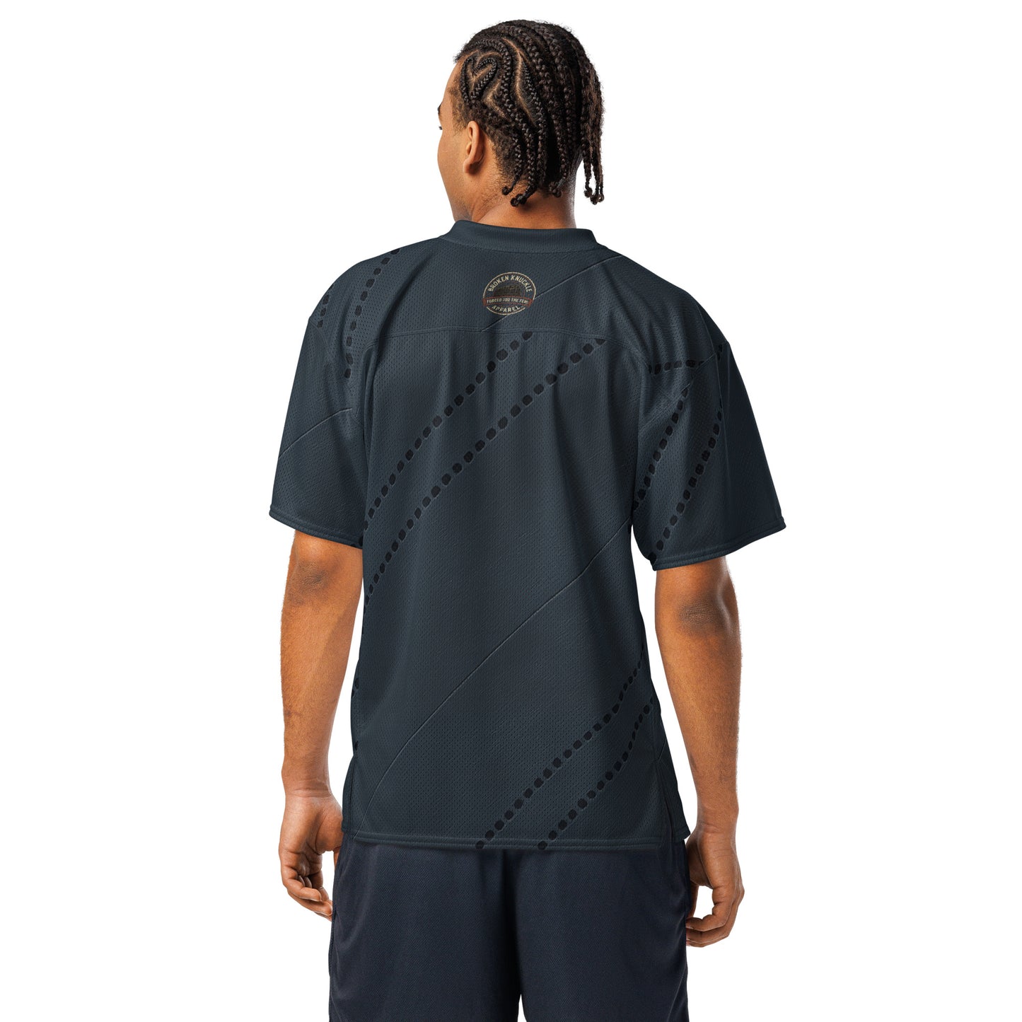 Person wearing a dark gray athletic outfit with a visible brand logo on the back.