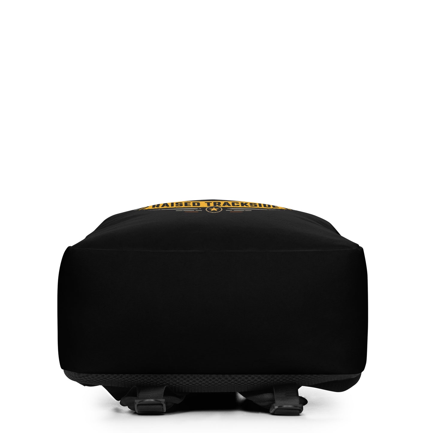 Black minimalist backpack featuring a colorful graphic design. The main text reads "RAIL KID" in large, bold letters, with a yellow banner underneath reading "RAISED TRACKSIDE". The design includes a railroad crossing signal with glowing red lights, a compass, a diesel locomotive train, and a mountain track badge on a dark background.
