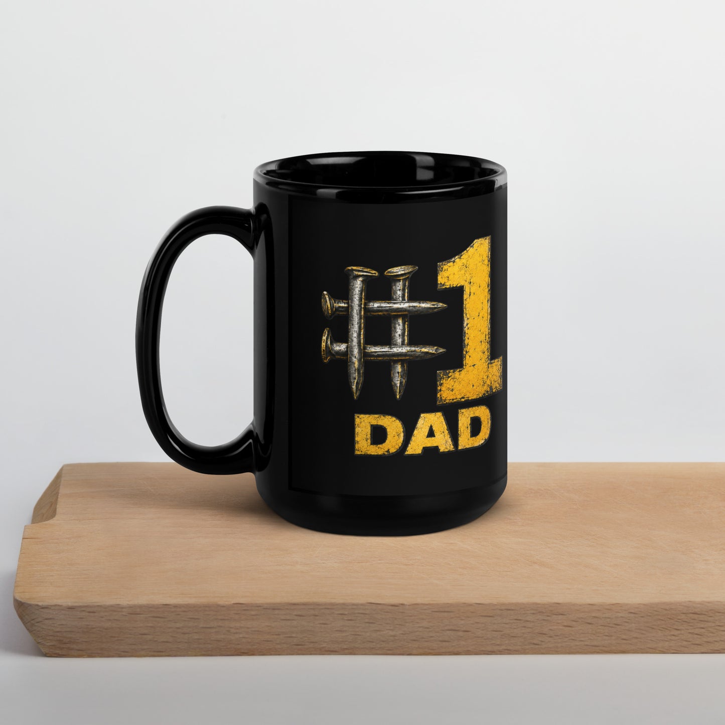 Black 15-ounce glossy coffee mug featuring a hashtag symbol made of four crossed metal railroad spikes next to a large, distressed yellow number 1, with the word DAD in matching distressed yellow text directly below.