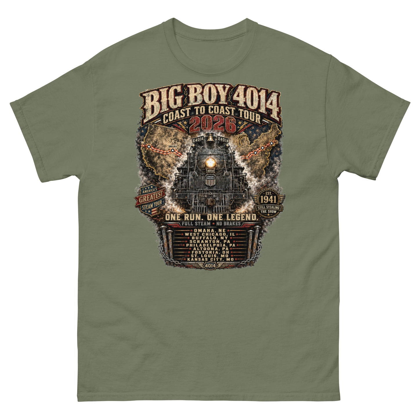 Army green t-shirt featuring a highly detailed, industrial graphic of the Big Boy 4014 steam locomotive backed by a US map, with text reading "BIG BOY 4014 COAST TO COAST TOUR 2026", "ONE RUN. ONE LEGEND.", and a roster of tour stops from Omaha to Kansas City surrounded by metal spikes and chains.