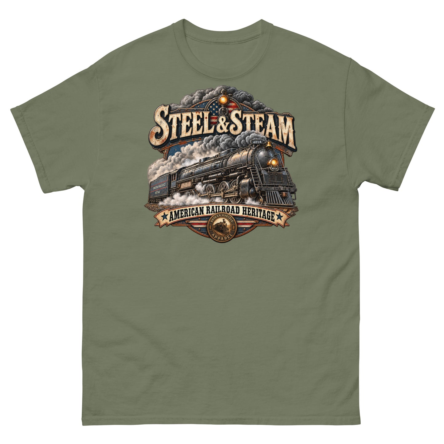 Army green classic t-shirt featuring a highly detailed vintage graphic. A steam locomotive charges forward surrounded by smoke, with an American flag motif in the background. Vintage distressed text reads "STEEL & STEAM" at the top and "AMERICAN RAILROAD HERITAGE" on a banner at the bottom, just above a round Broken Knuckle Apparel badge.