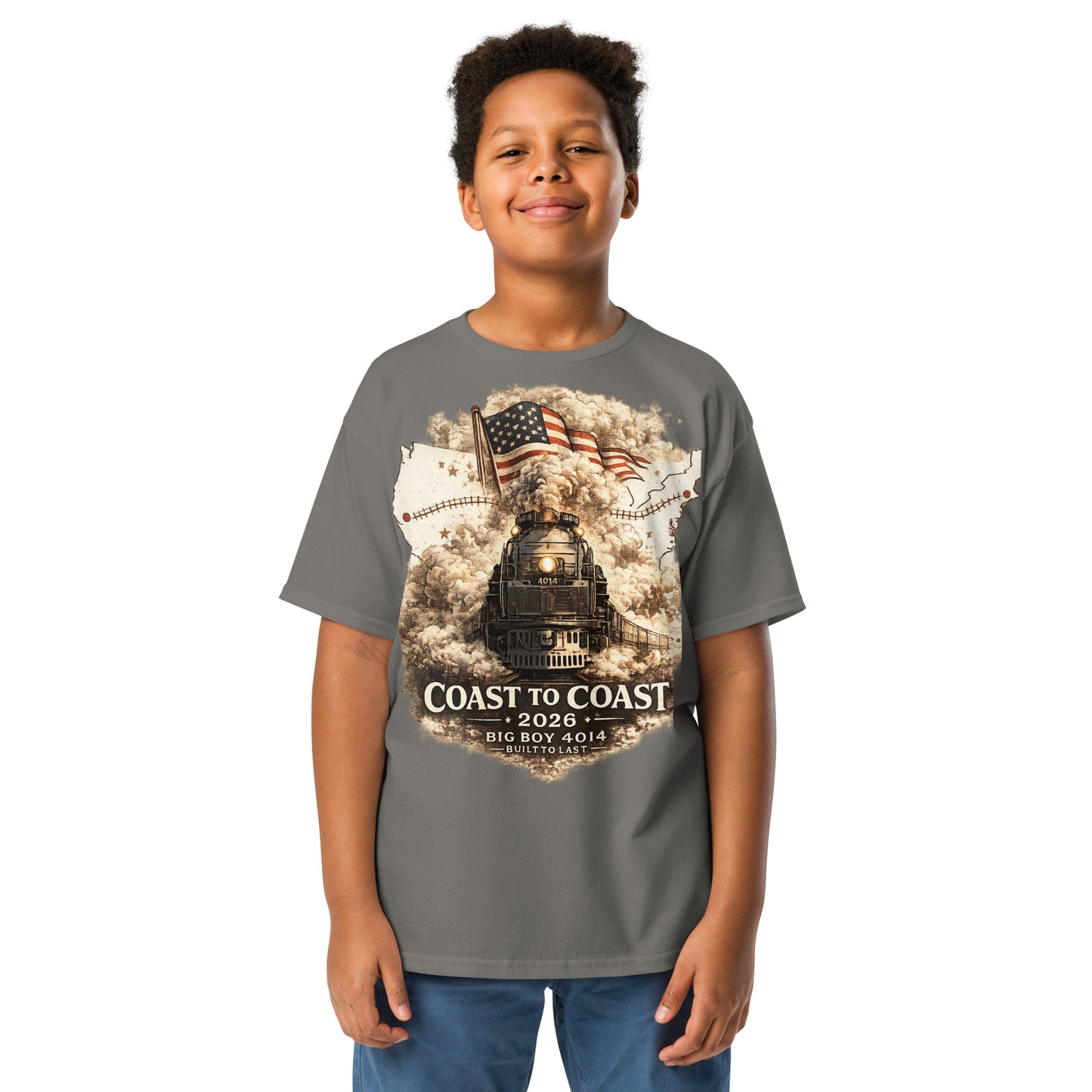 Child wearing a gray t-shirt featuring the Big Boy 4014 steam locomotive, a waving American flag, and a US map showing a track route, with text reading "Coast to Coast 2026", "Big Boy 4014", and "Built To Last".