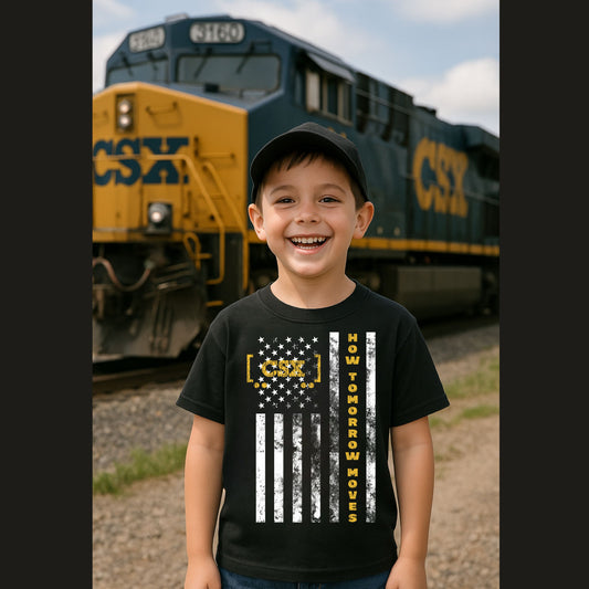 Child wearing a black CSX t-shirt with a train in the background