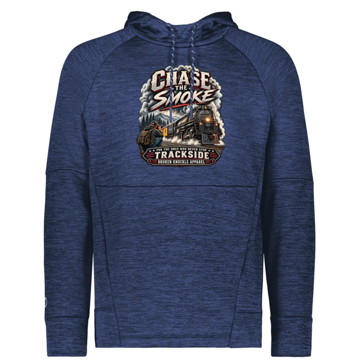 Blue Holloway performance fleece hoody featuring a graphic of a photographer with a backpack kneeling trackside, taking a picture of a large steam locomotive rolling through a forest landscape. Bold distressed text reads "CHASE THE SMOKE" at the top and "FOR THE ONES WHO NEVER STOP TRACKSIDE" in a vintage banner at the bottom.