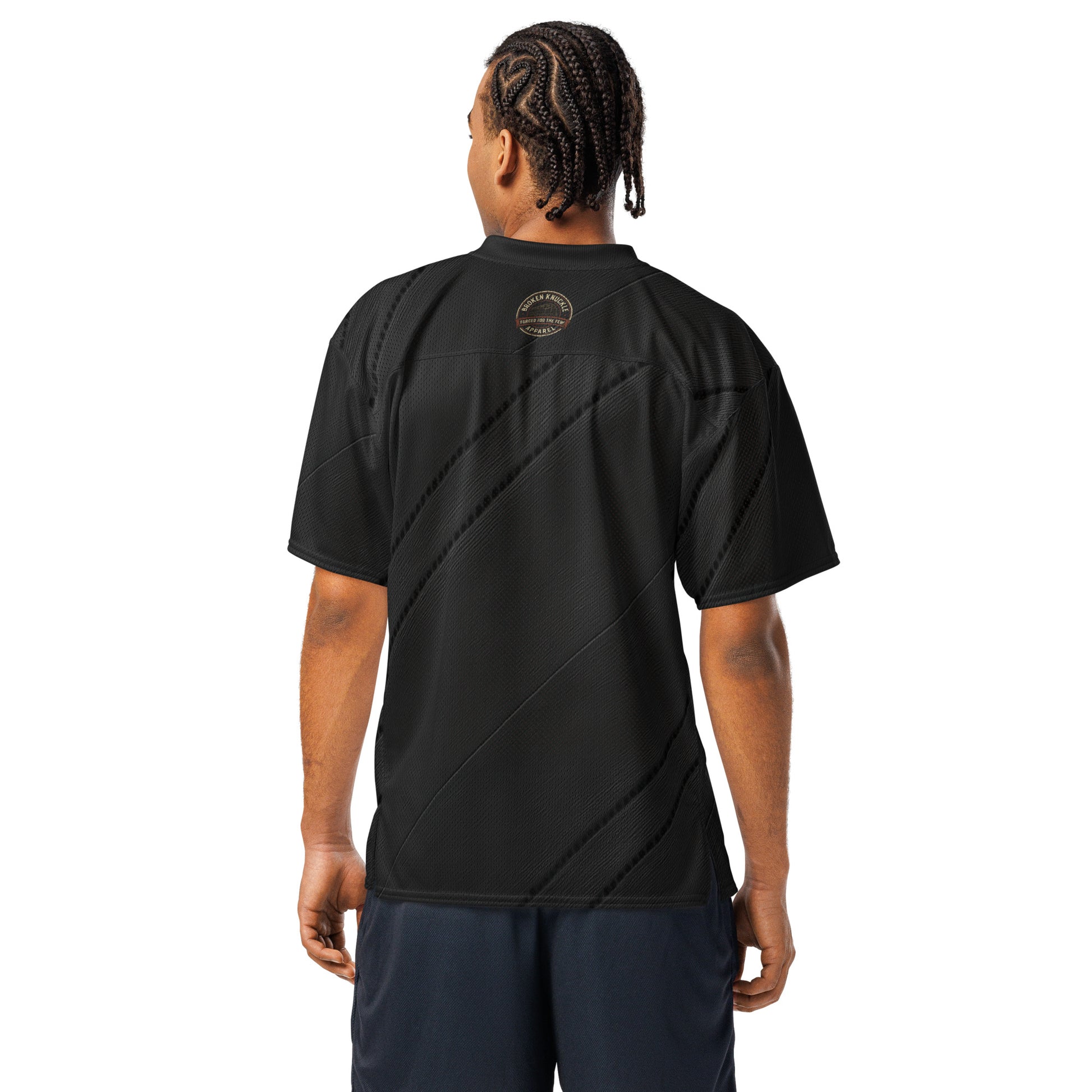 Person wearing a black t-shirt with a logo on the back against a white background