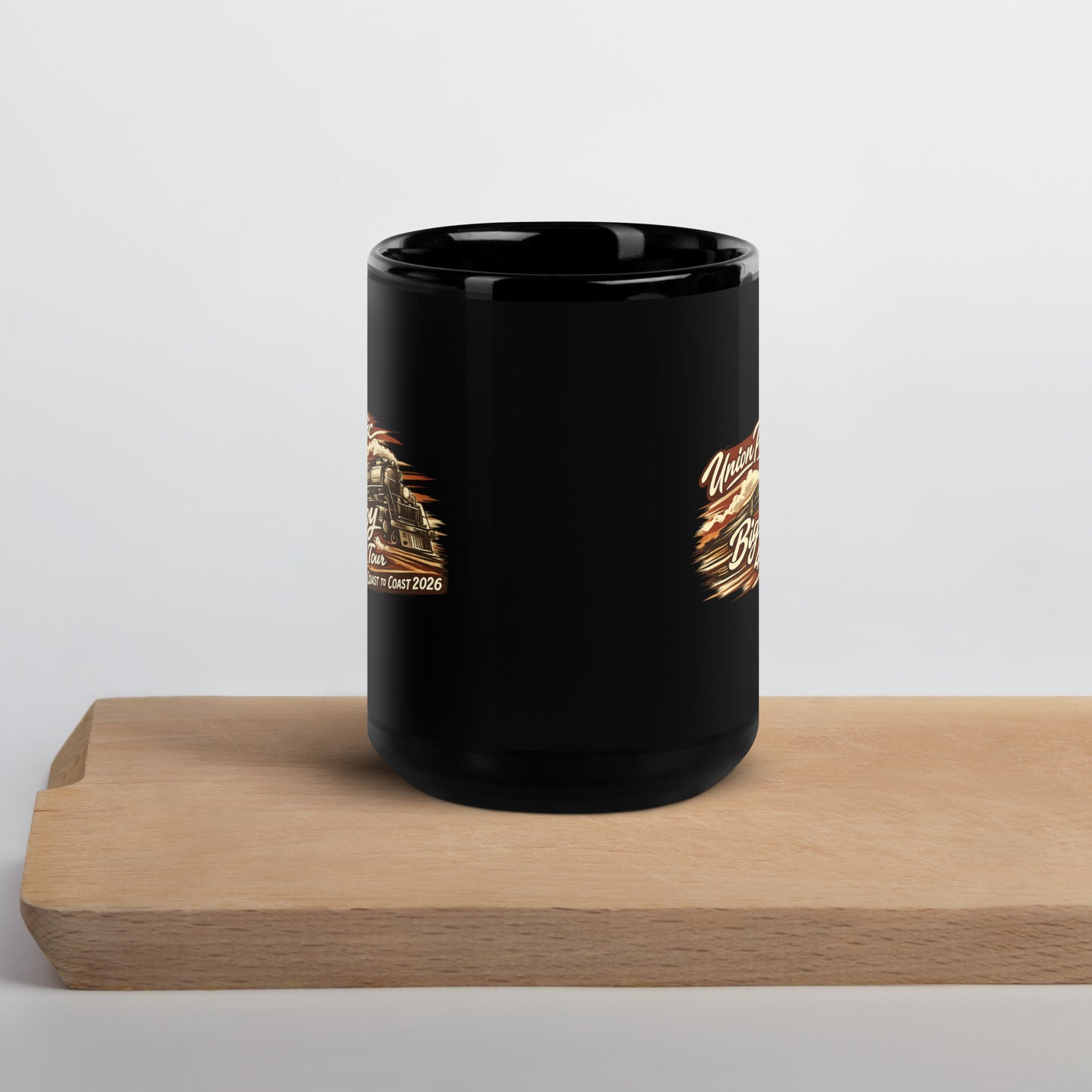 Black mug with gold design on a wooden block against a white background