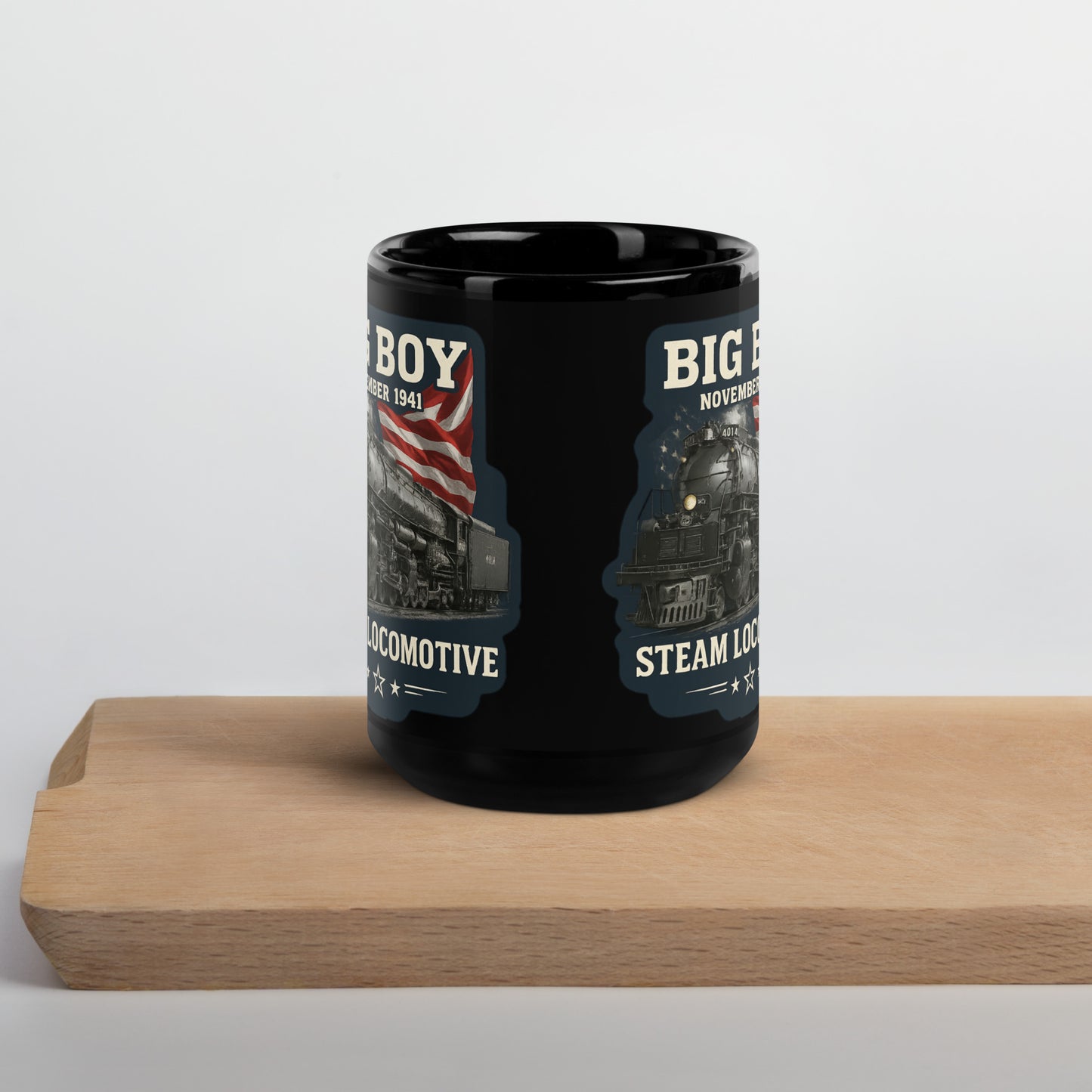 Black 15-ounce glossy coffee mug featuring a vintage graphic of the Big Boy 4014 steam locomotive backed by an American flag, with text reading "BIG BOY", "NOVEMBER 1941", and "STEAM LOCOMOTIVE".