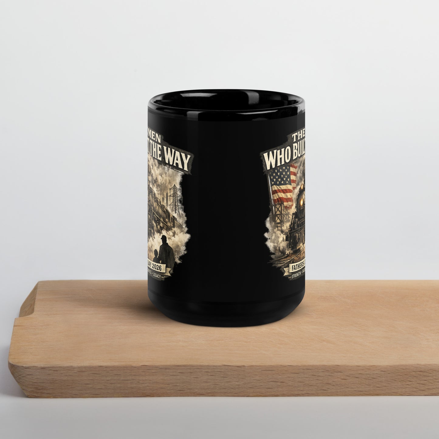 Black 15-ounce glossy coffee mug featuring a cinematic graphic of a steam locomotive, an American flag, and a silhouette of a father and child holding hands, with text reading "The Men Who Built The Way", "Fathers Day 2026", and "Strength - Sacrifice - Legacy".
