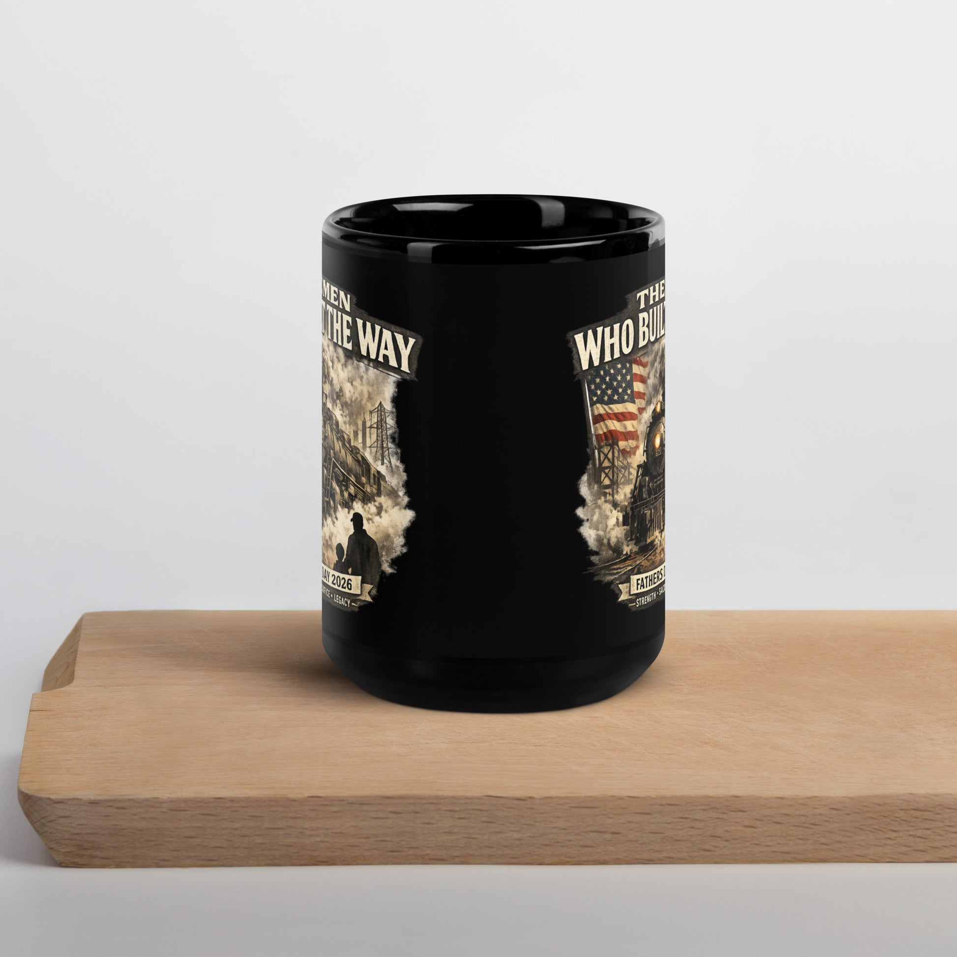 Black 15-ounce glossy coffee mug featuring a cinematic graphic of a steam locomotive, an American flag, and a silhouette of a father and child holding hands, with text reading "The Men Who Built The Way", "Fathers Day 2026", and "Strength - Sacrifice - Legacy".