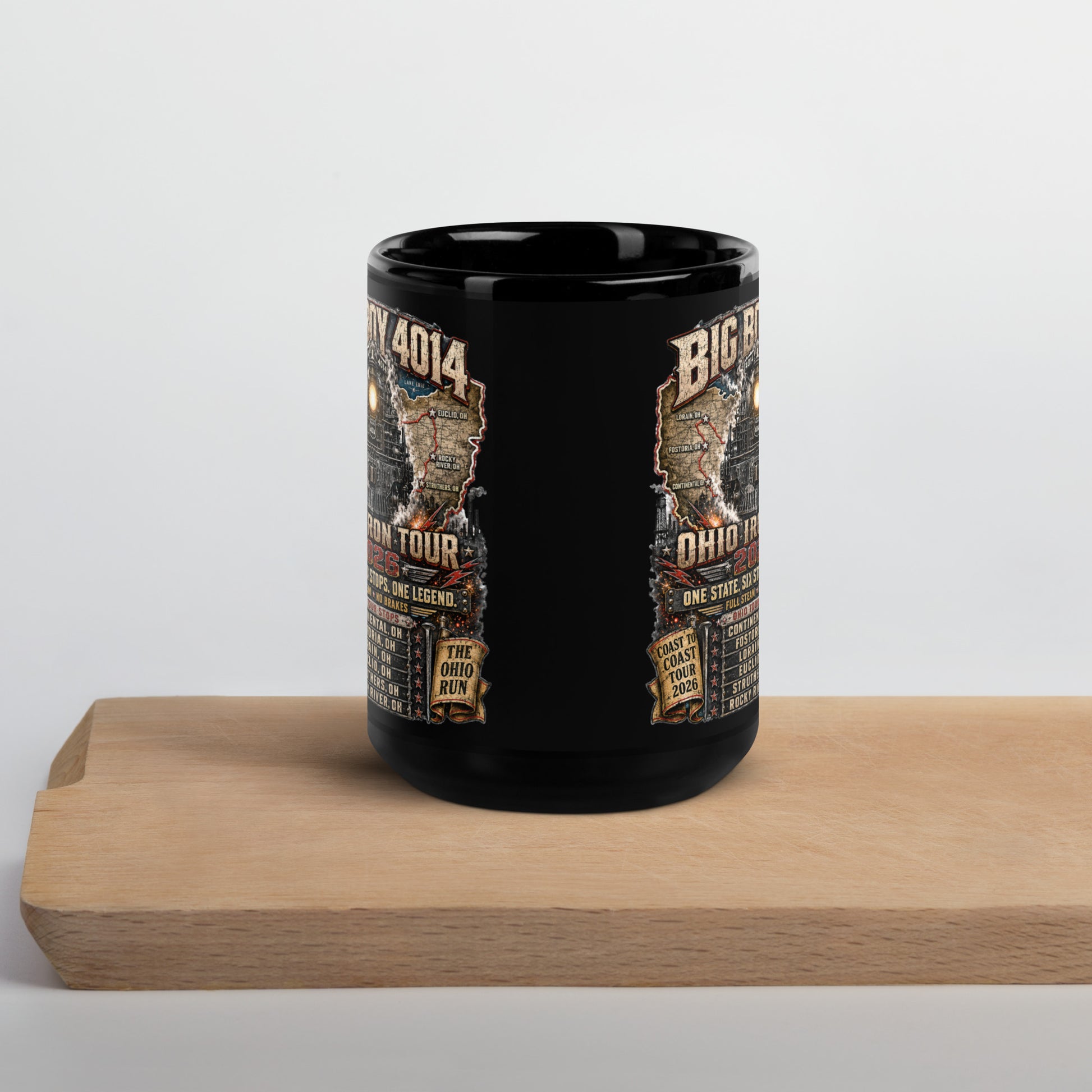 Black 15-ounce glossy coffee mug featuring a highly detailed graphic of the Big Boy 4014 steam locomotive backed by a map of Ohio. Text reads "BIG BOY 4014", "OHIO IRON TOUR 2026", "ONE STATE. SIX STOPS. ONE LEGEND.", alongside banners for "COAST TO COAST TOUR 2026" and "THE OHIO RUN", plus a detailed roster of six Ohio tour stops.