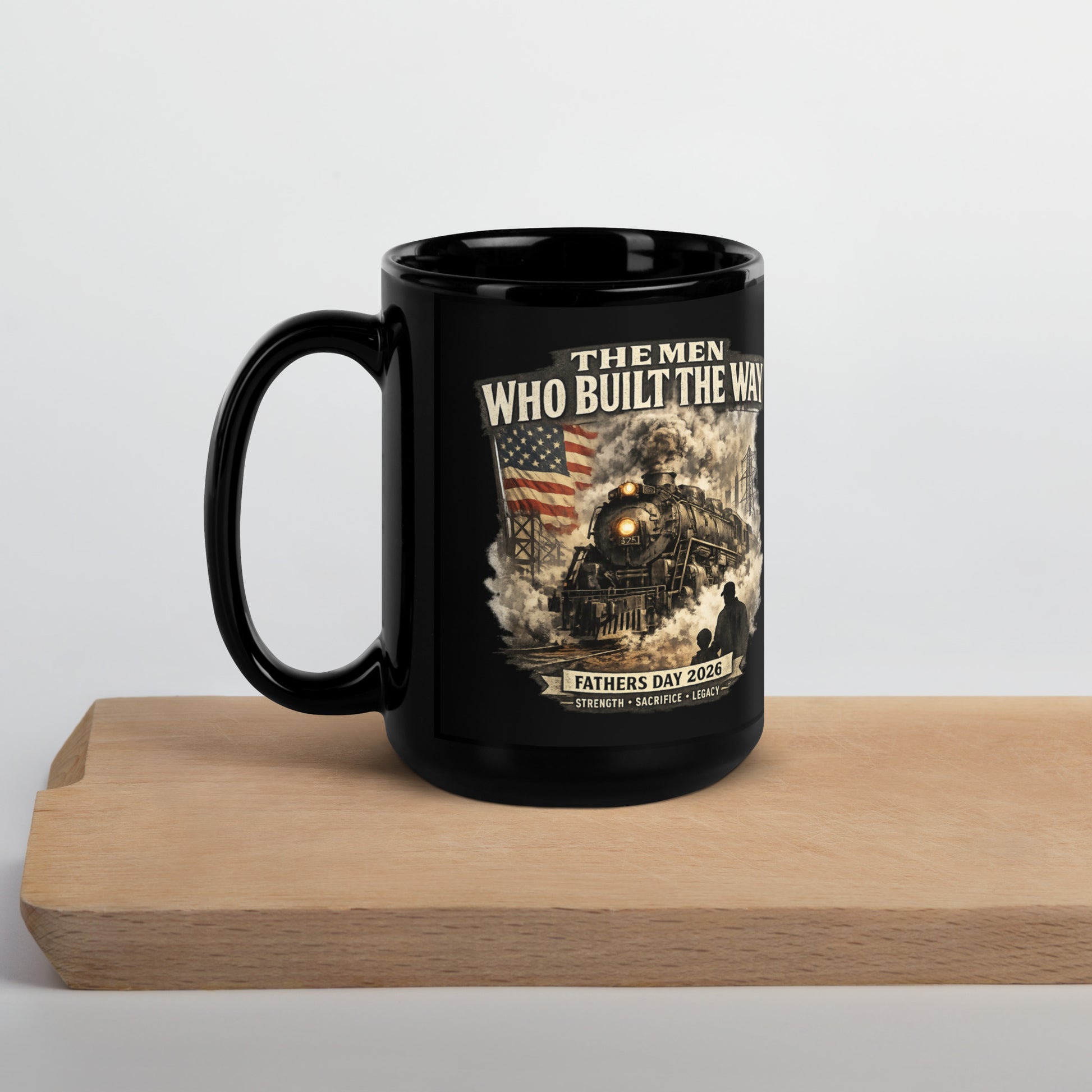 Black 15-ounce glossy coffee mug featuring a cinematic graphic of a steam locomotive, an American flag, and a silhouette of a father and child holding hands, with text reading "The Men Who Built The Way", "Fathers Day 2026", and "Strength - Sacrifice - Legacy".