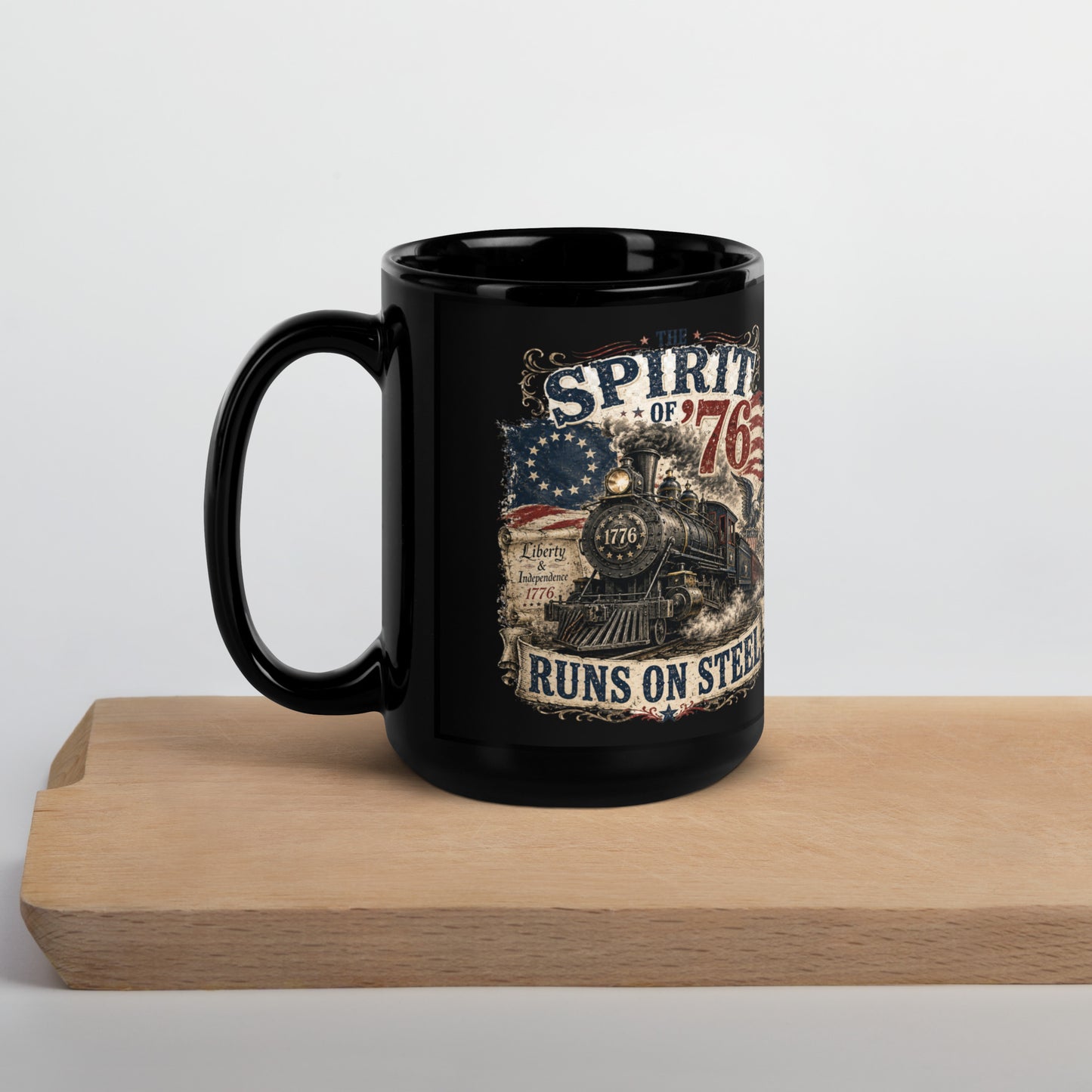 Black 15-ounce glossy coffee mug featuring a highly detailed vintage graphic. Distressed text reads "THE SPIRIT OF '76". The center shows a classic steam locomotive with "1776" on the front plate, bursting from a 13-star Betsy Ross American flag. A bald eagle flies on the right, and a parchment scroll on the left reads "Liberty & Independence 1776". A banner at the bottom reads "RUNS ON STEEL".