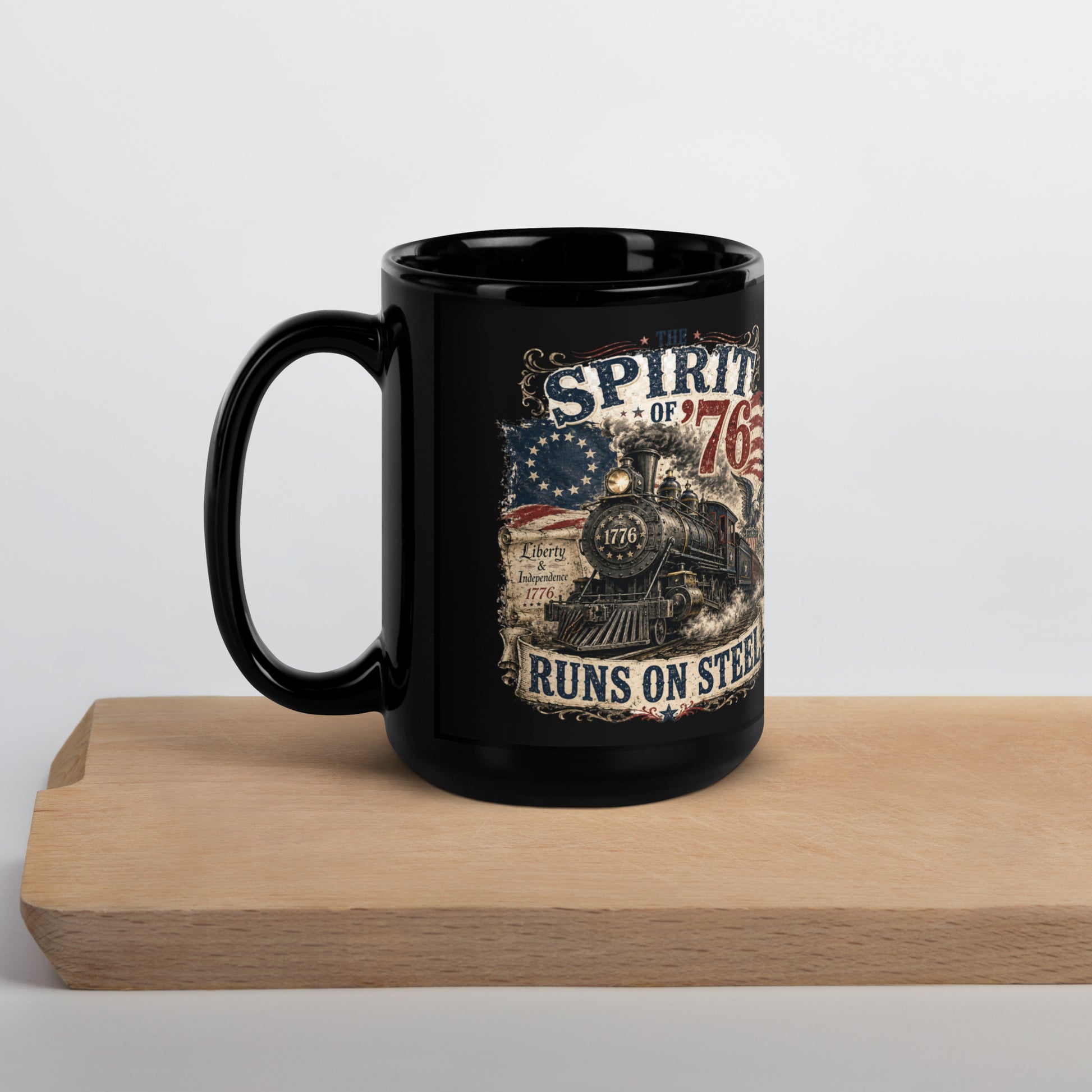 Black 15-ounce glossy coffee mug featuring a highly detailed vintage graphic. Distressed text reads "THE SPIRIT OF '76". The center shows a classic steam locomotive with "1776" on the front plate, bursting from a 13-star Betsy Ross American flag. A bald eagle flies on the right, and a parchment scroll on the left reads "Liberty & Independence 1776". A banner at the bottom reads "RUNS ON STEEL".