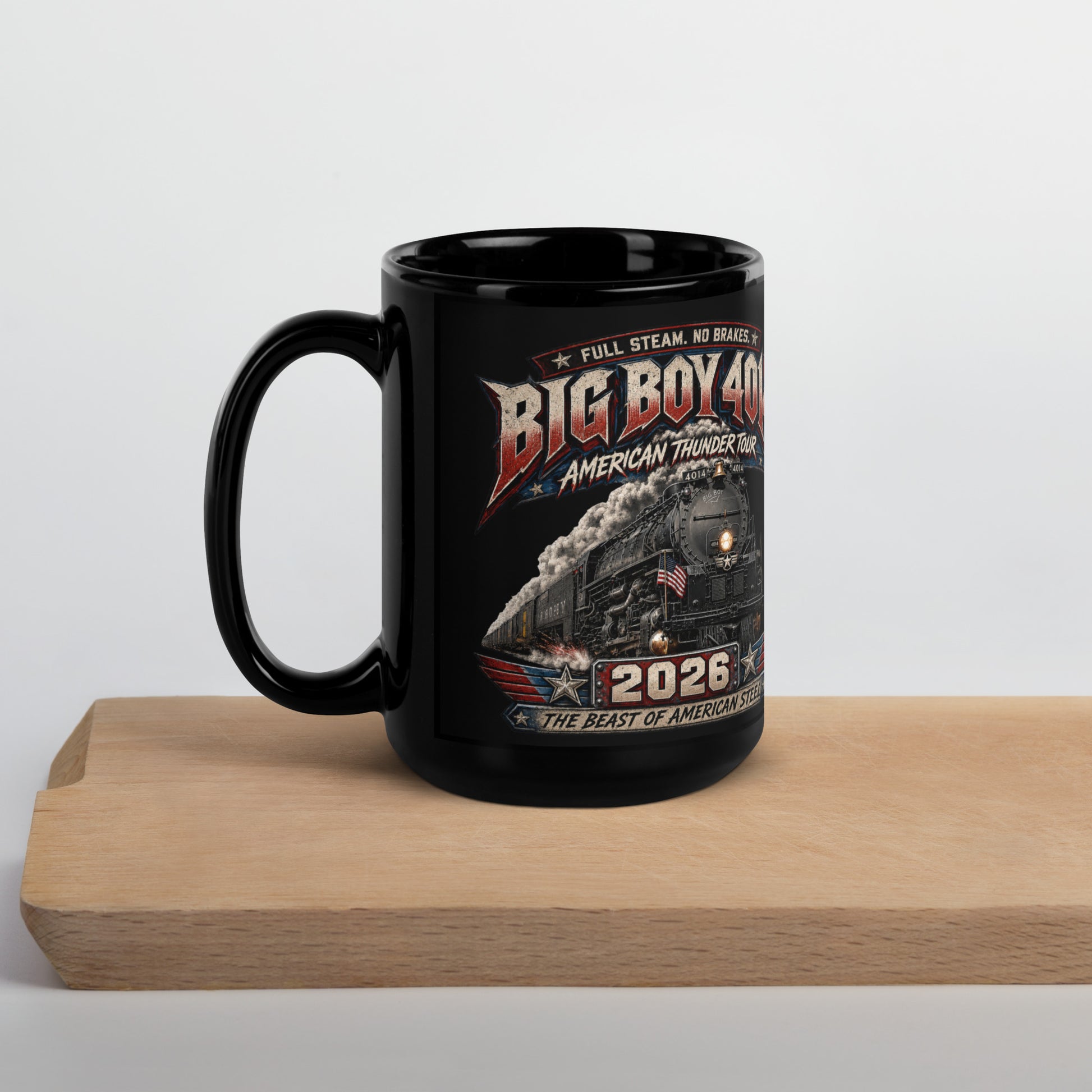 Black 15-ounce glossy coffee mug featuring a dynamic graphic of the Big Boy 4014 steam locomotive charging forward with billowing smoke and an American flag on the front. Bold text reads "FULL STEAM. NO BRAKES.", "BIG BOY 4014", "AMERICAN THUNDER TOUR", "2026", and "THE BEAST OF AMERICAN STEEL".