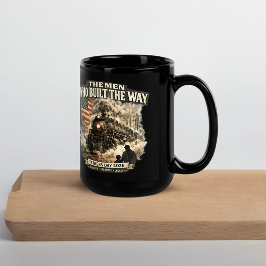 Black 15-ounce glossy coffee mug featuring a cinematic graphic of a steam locomotive, an American flag, and a silhouette of a father and child holding hands, with text reading "The Men Who Built The Way", "Fathers Day 2026", and "Strength - Sacrifice - Legacy".