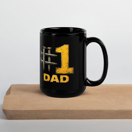 Black 15-ounce glossy coffee mug featuring a hashtag symbol made of four crossed metal railroad spikes next to a large, distressed yellow number 1, with the word DAD in matching distressed yellow text directly below.