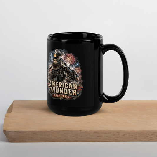 Black 15-ounce glossy coffee mug featuring a 1776 steam locomotive charging through smoke and patriotic fireworks, with an American flag and distressed text reading "AMERICAN THUNDER" over a red, white, and blue banner, followed by "JULY 4TH 2026".
