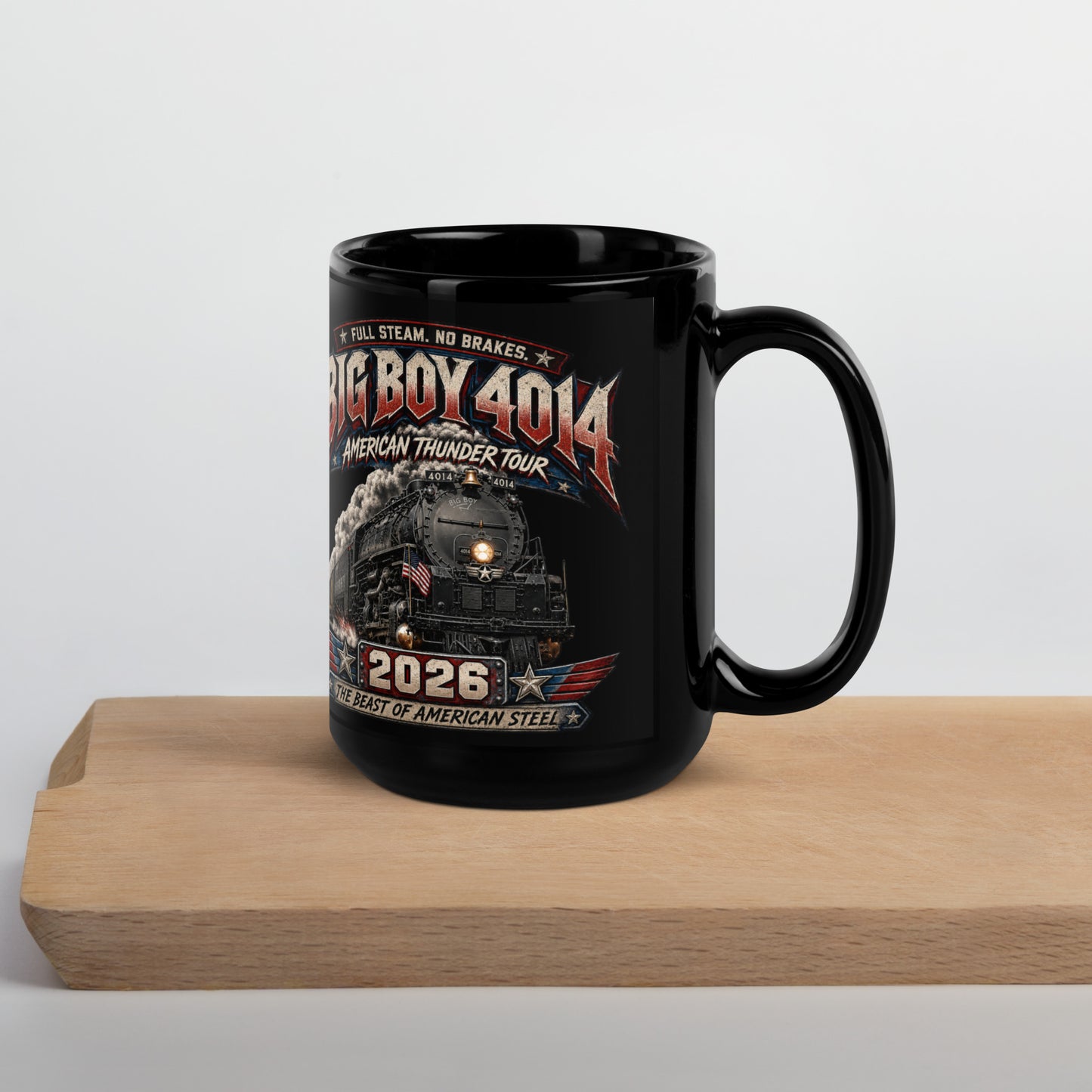 Black 15-ounce glossy coffee mug featuring a dynamic graphic of the Big Boy 4014 steam locomotive charging forward with billowing smoke and an American flag on the front. Bold text reads "FULL STEAM. NO BRAKES.", "BIG BOY 4014", "AMERICAN THUNDER TOUR", "2026", and "THE BEAST OF AMERICAN STEEL".