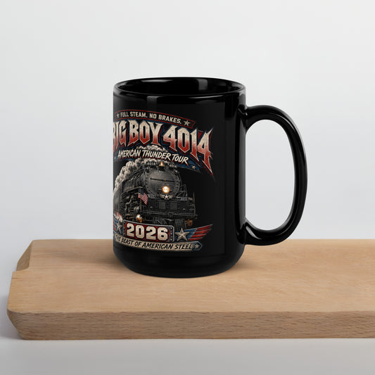 Black 15-ounce glossy coffee mug featuring a dynamic graphic of the Big Boy 4014 steam locomotive charging forward with billowing smoke and an American flag on the front. Bold text reads "FULL STEAM. NO BRAKES.", "BIG BOY 4014", "AMERICAN THUNDER TOUR", "2026", and "THE BEAST OF AMERICAN STEEL".