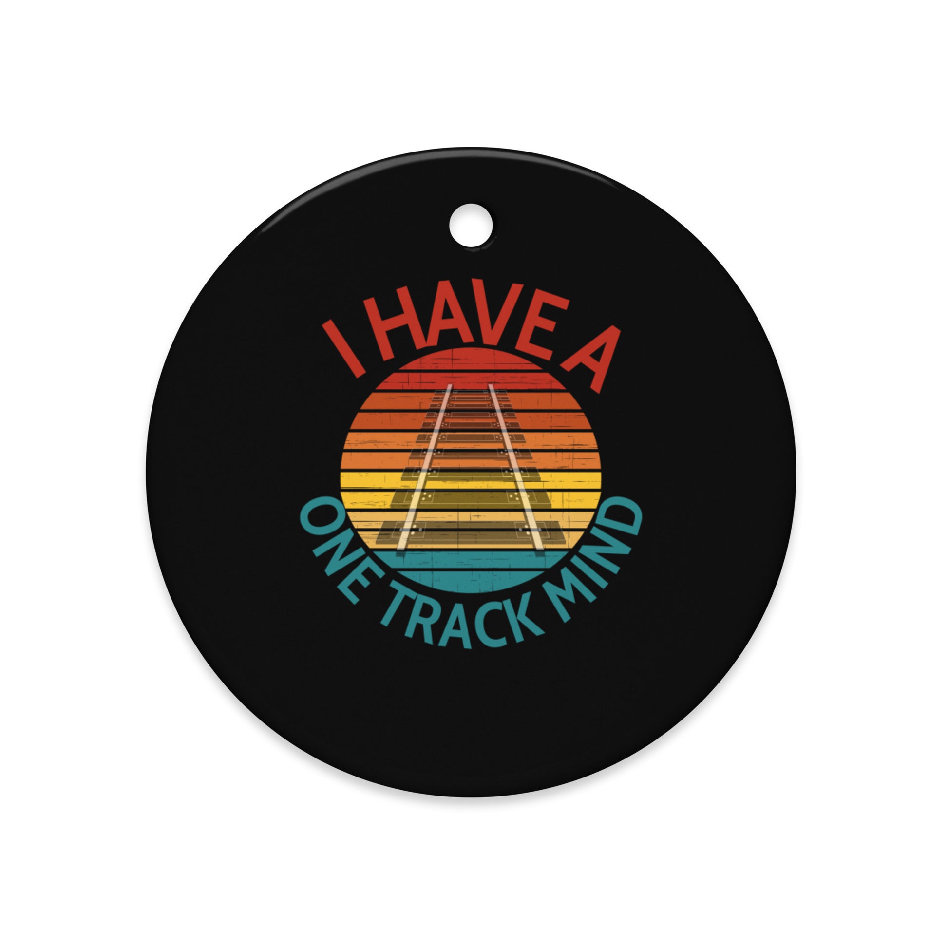 Round black ceramic ornament with colorful design and text 'I Have a One Track Mind' on a white background