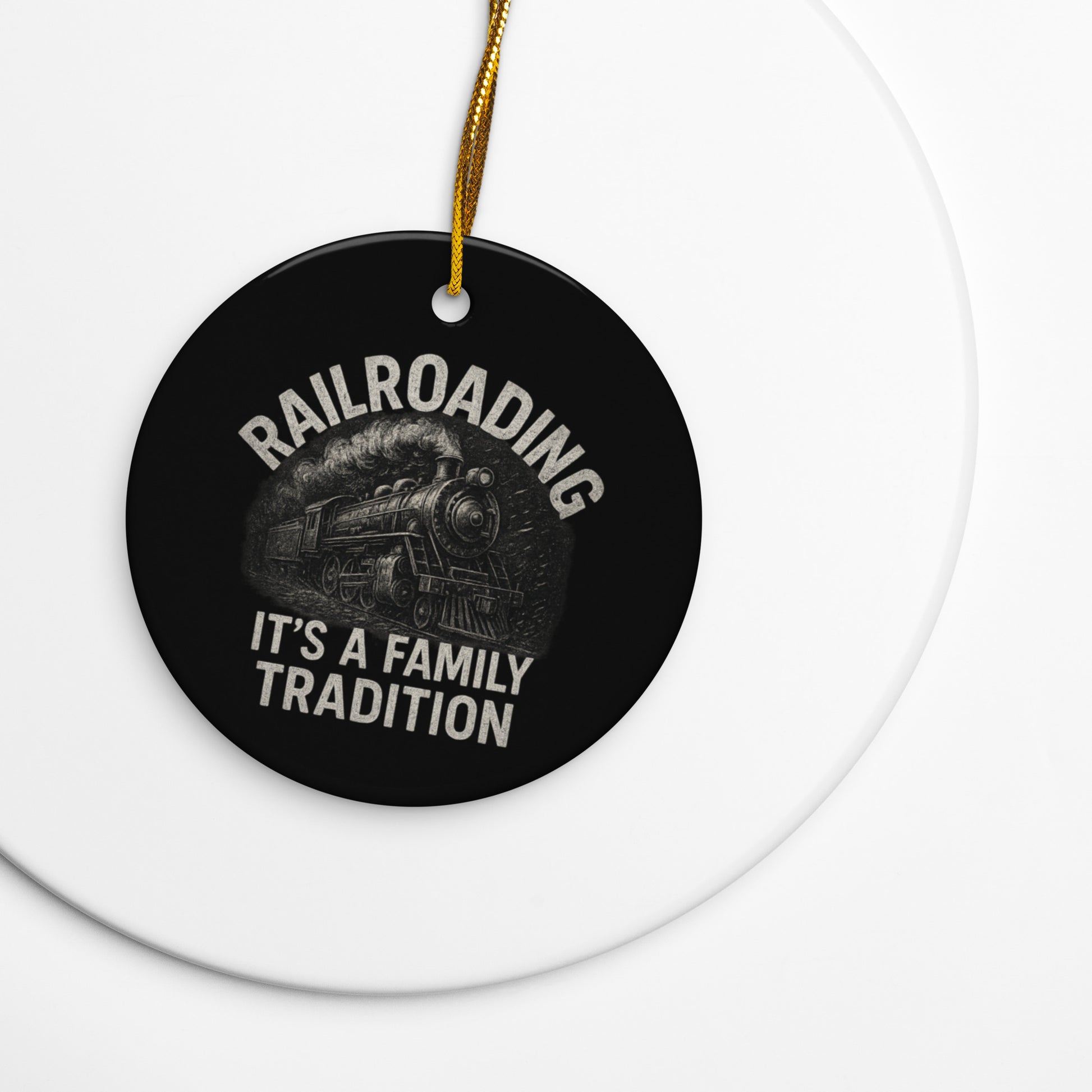 Round black ornament with train graphic and text on a white background