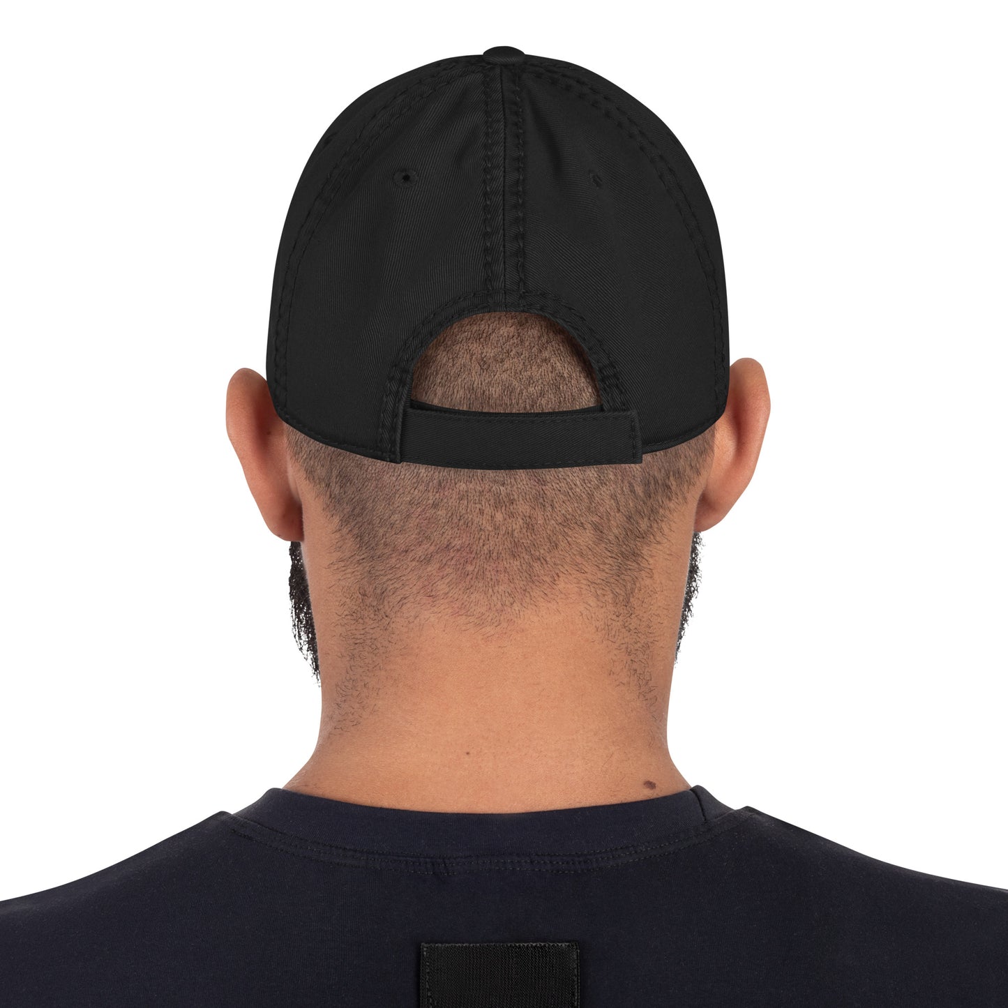 Black cap worn backwards on a person with a white background