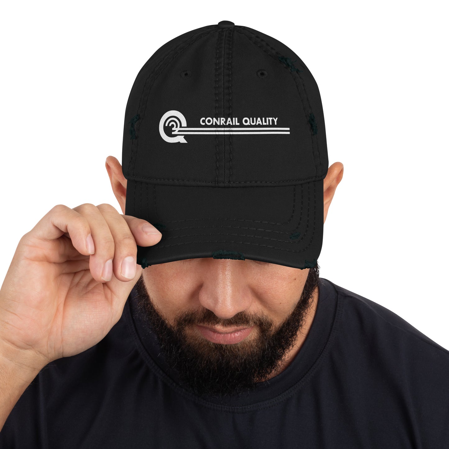 Person wearing a black cap with 'Conrail Quality' logo on a white background
