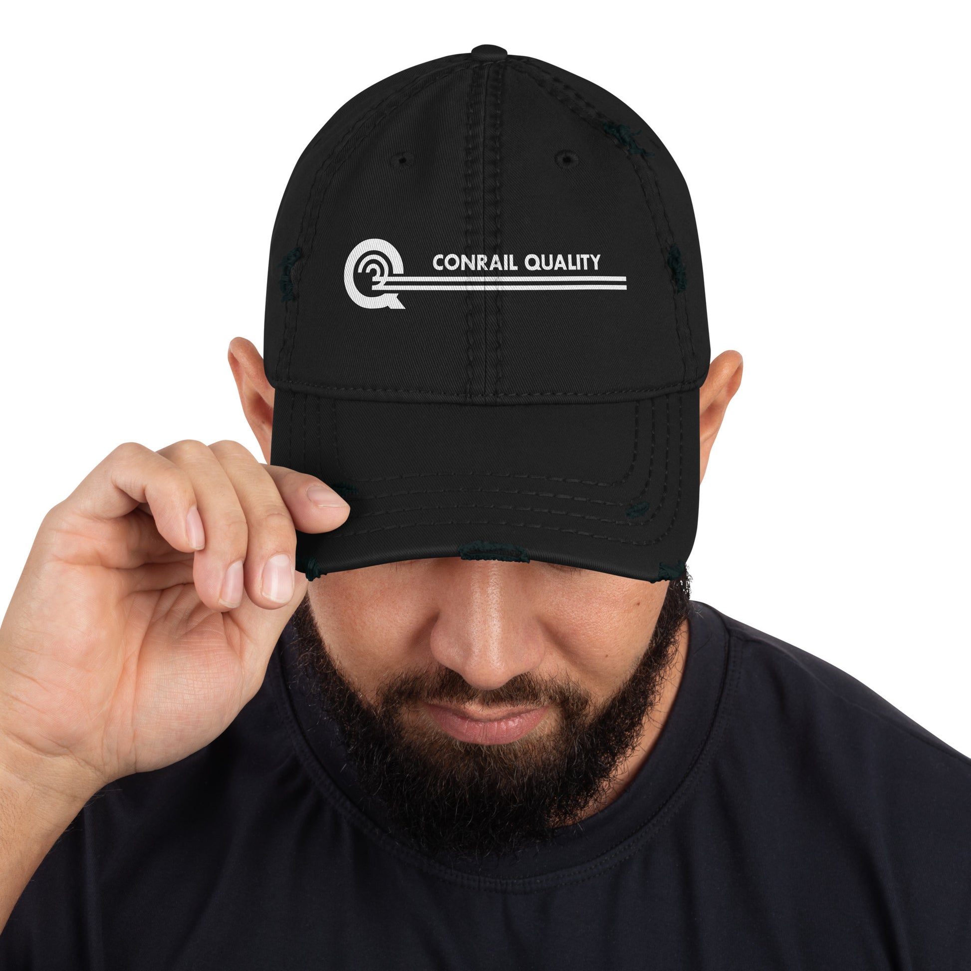 Person wearing a black cap with 'Conrail Quality' logo on a white background