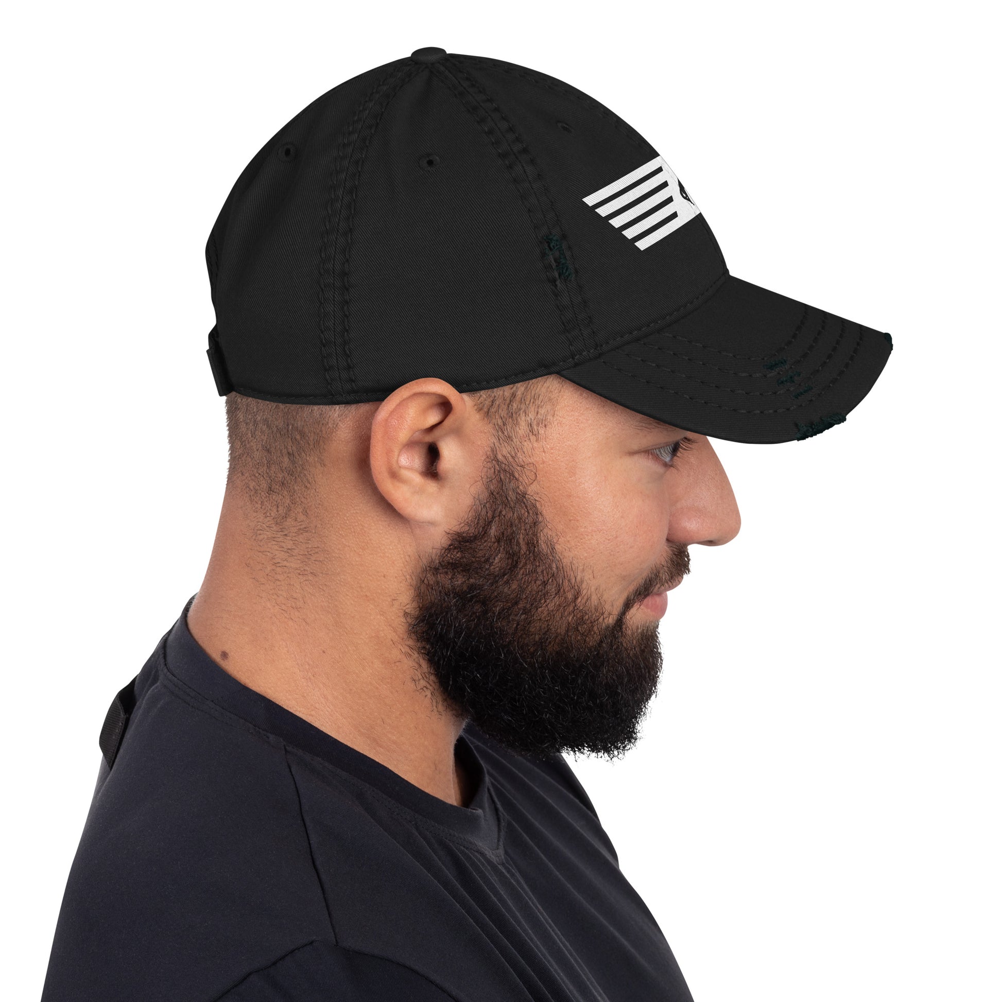 Man wearing a black cap with a white logo on a white background