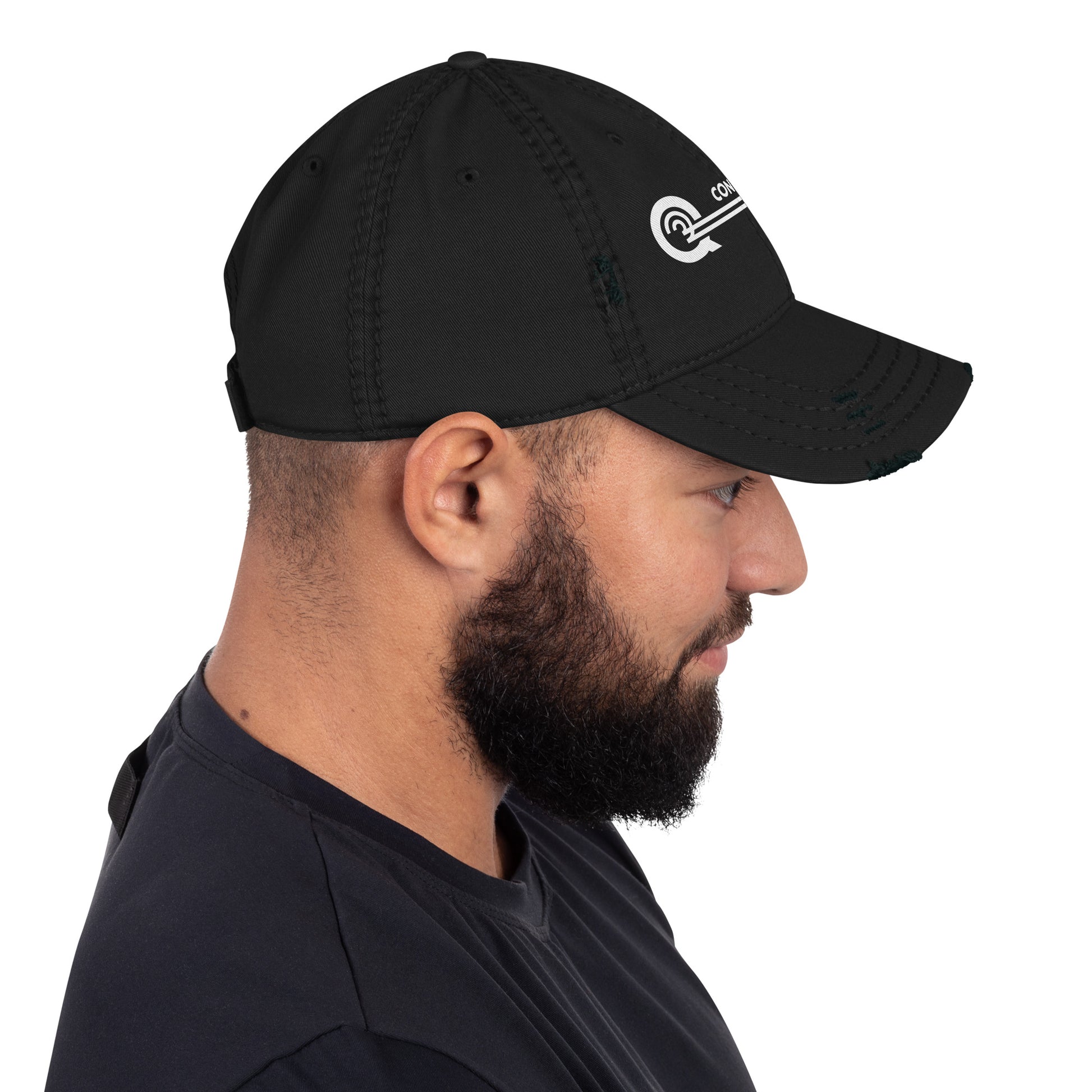 Man wearing a black cap with a logo on a white background
