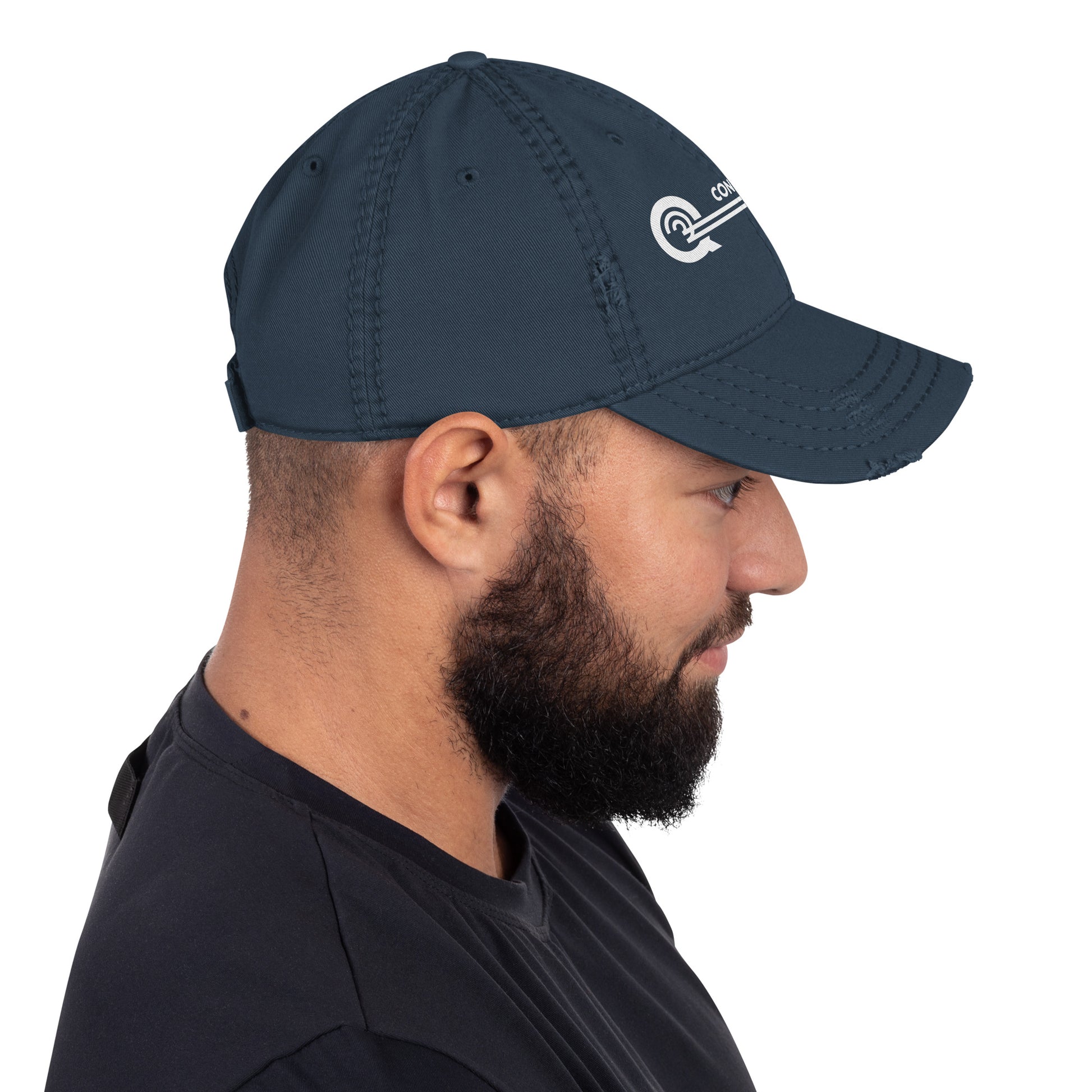 Man wearing a navy cap with a logo on a white background