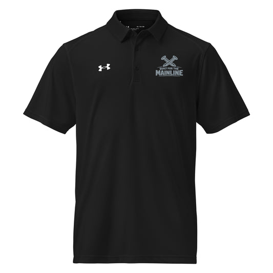 Black Under Armour men's polo shirt featuring a graphic of crossed railroad spikes above the text "BUILT FOR THE MAINLINE" on the left chest. A white Under Armour logo is displayed on the right chest. The shirt has a classic collar and a multi-button placket.