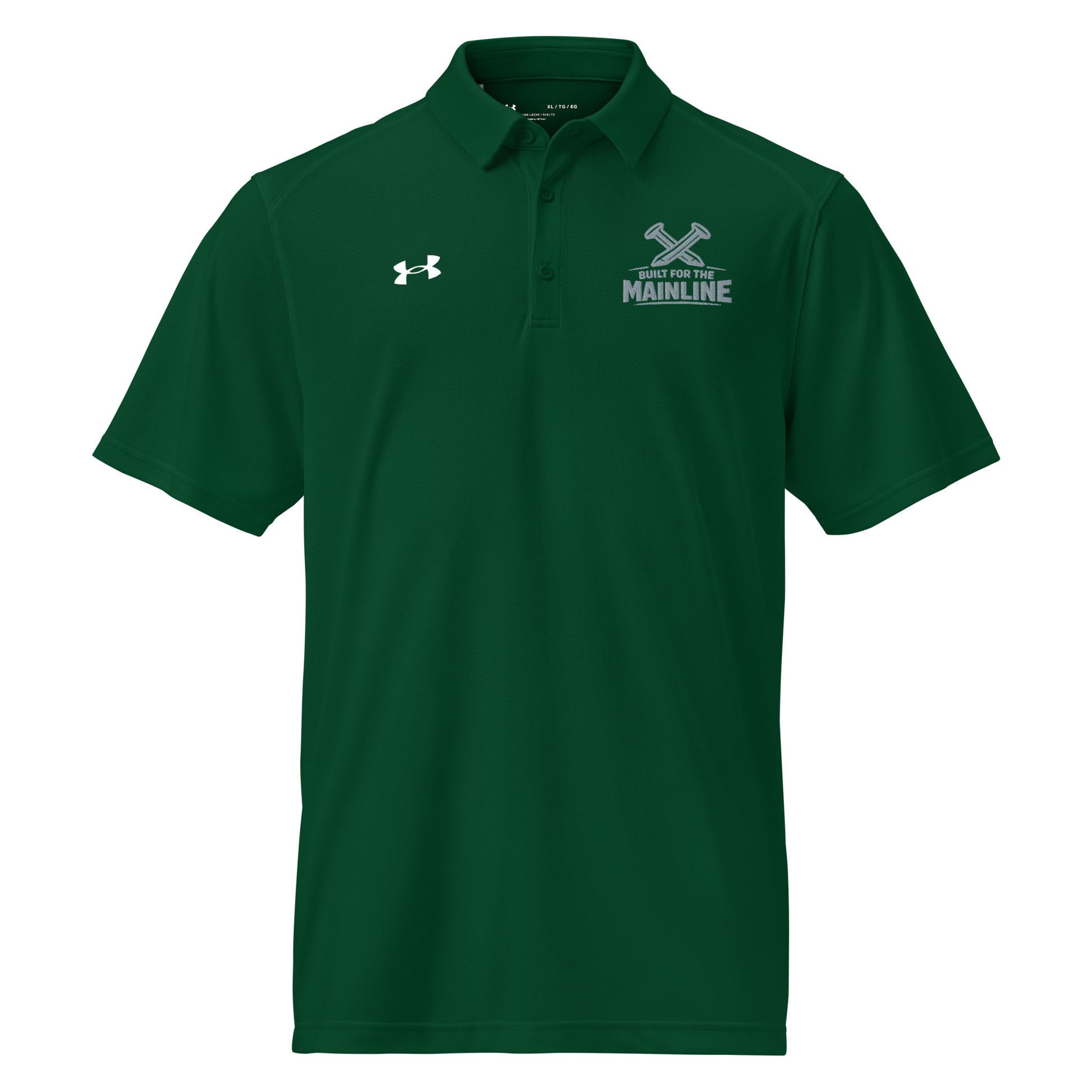 Forest green Under Armour men's polo shirt featuring a graphic of crossed railroad spikes above the text "BUILT FOR THE MAINLINE" on the left chest. A white Under Armour logo is displayed on the right chest. The shirt has a classic collar and a multi-button placket.