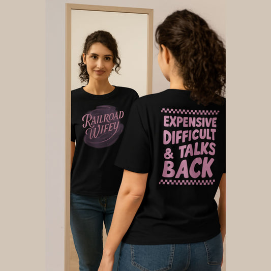 Woman wearing a black t-shirt with text, looking at herself in the mirror.