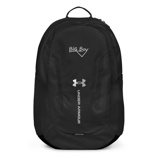 Black Under Armour backpack featuring the classic white chalk-style "Big Boy" script logo on the top front panel. A silver Under Armour logo is centered above the vertical text "UNDER ARMOUR". The bottom of the bag features the UA Storm technology badge.