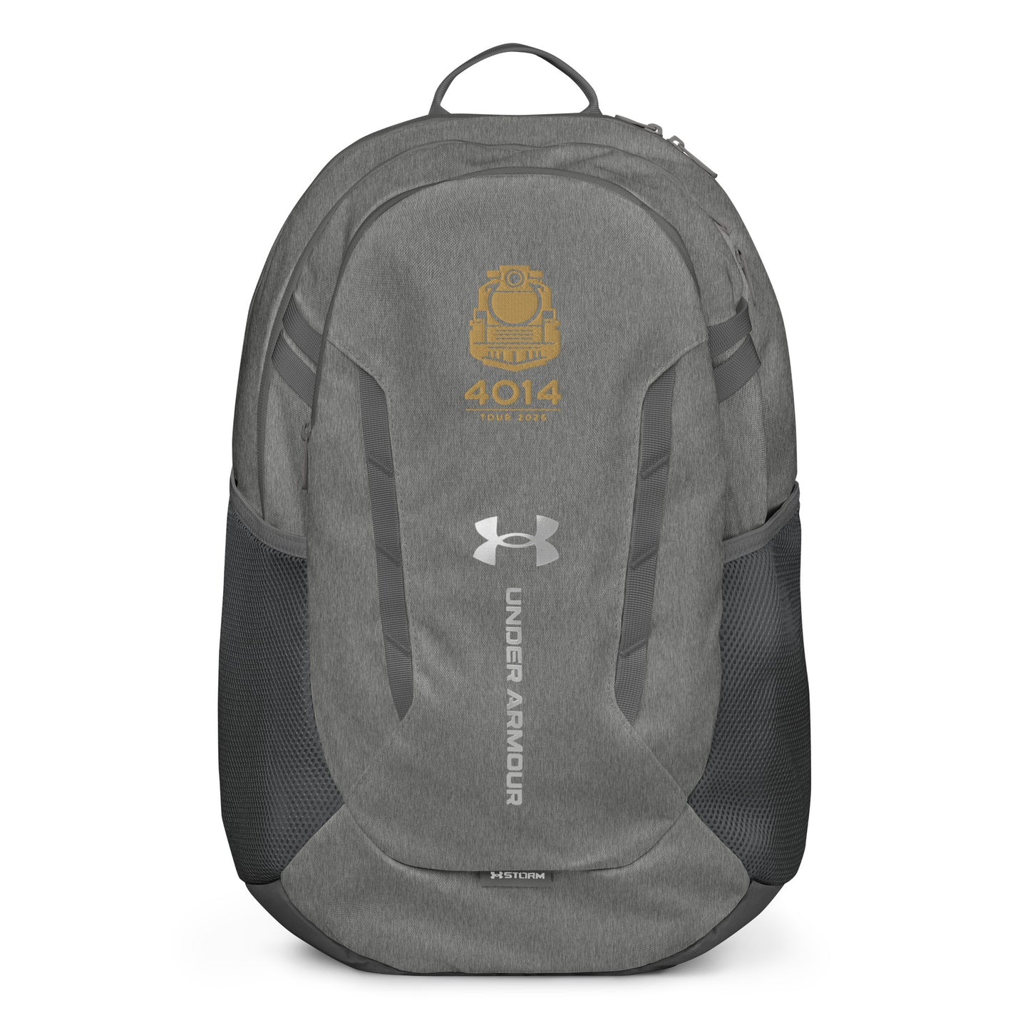 Silver Under Armour backpack featuring a gold graphic of a front-facing steam locomotive above the text "4014 TOUR 2026". The silver Under Armour logo is centered on the front above the vertical text "UNDER ARMOUR". The bottom of the bag features the UA Storm technology badge.