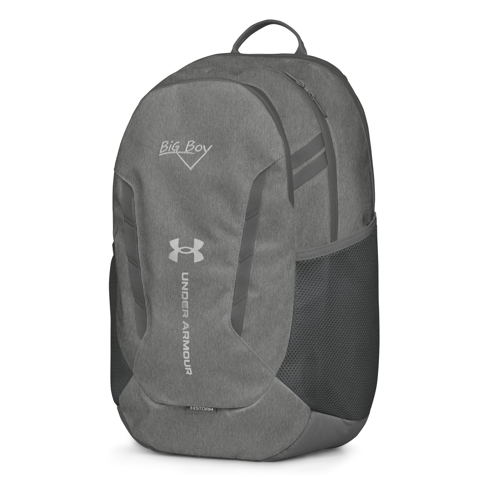 Gray Under Armour backpack featuring the classic white chalk-style "Big Boy" script logo on the top front panel. A silver Under Armour logo is centered above the vertical text "UNDER ARMOUR". The bottom of the bag features the UA Storm technology badge.