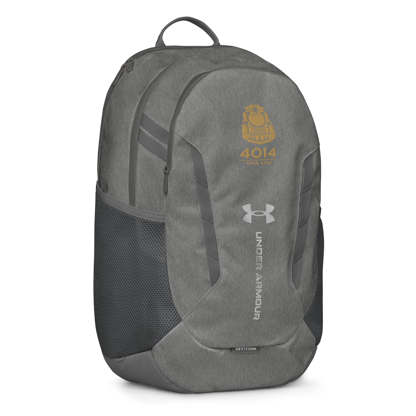 Silver Under Armour backpack featuring a gold graphic of a front-facing steam locomotive above the text "4014 TOUR 2026". The silver Under Armour logo is centered on the front above the vertical text "UNDER ARMOUR". The bottom of the bag features the UA Storm technology badge.