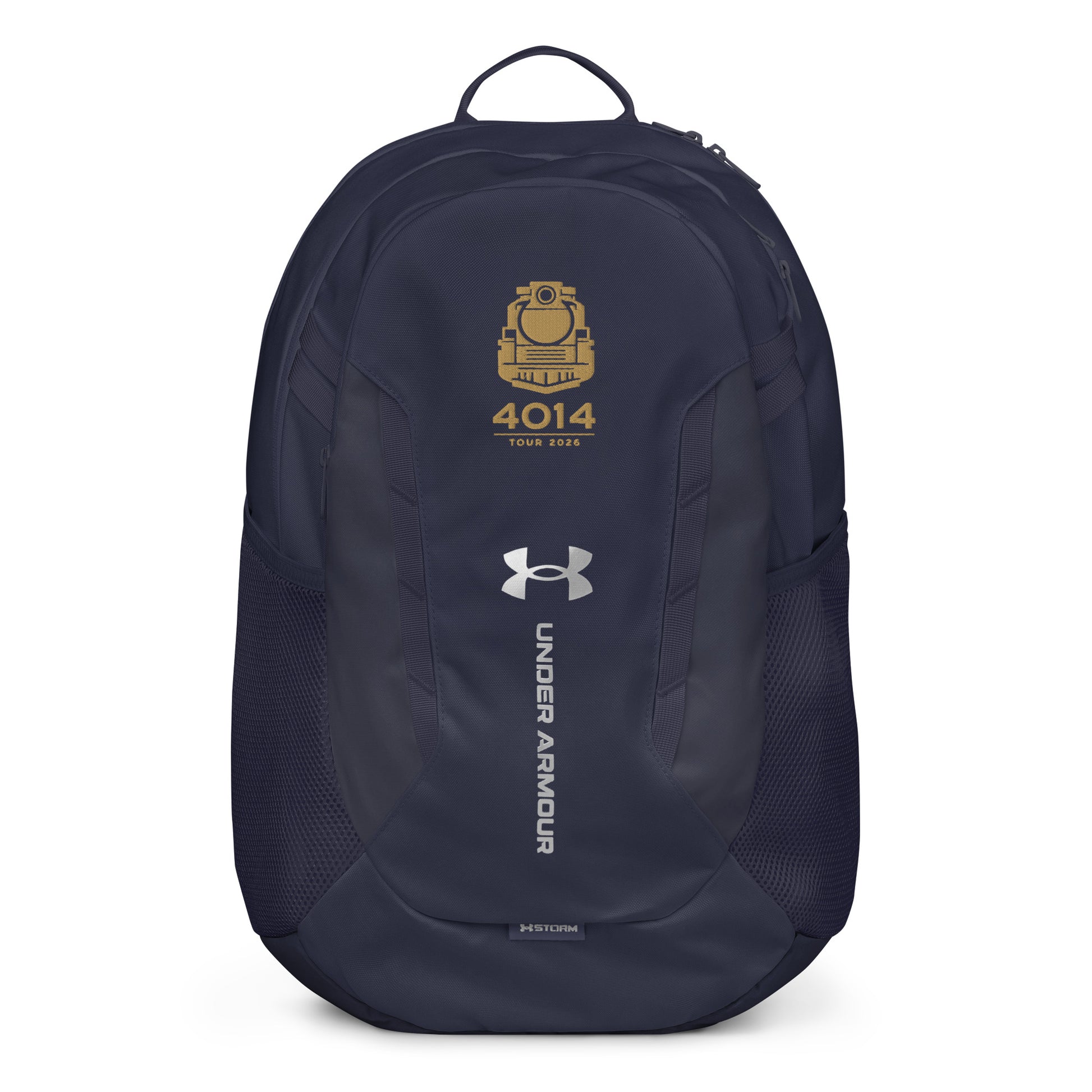 Navy Under Armour backpack featuring a gold graphic of a front-facing steam locomotive above the text "4014 TOUR 2026". The silver Under Armour logo is centered on the front above the vertical text "UNDER ARMOUR". The bottom of the bag features the UA Storm technology badge.