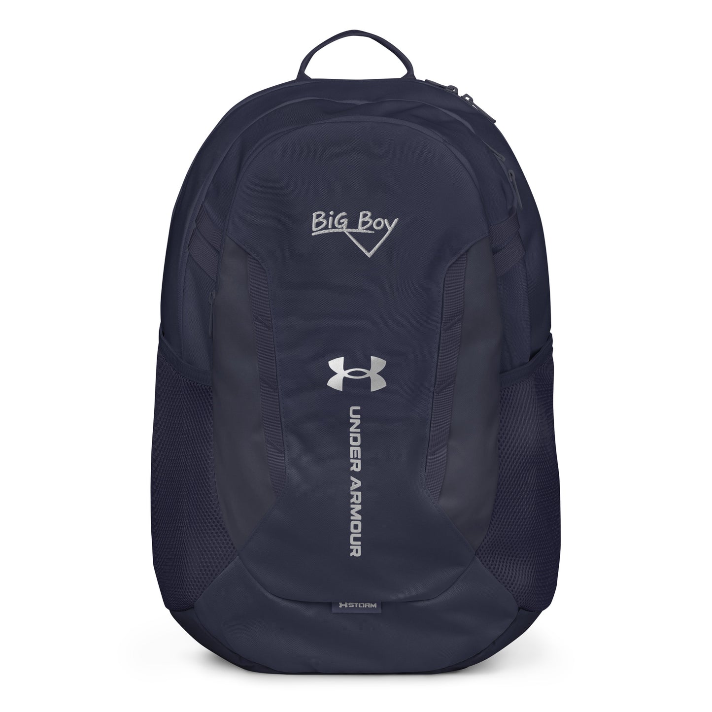 Navy Under Armour backpack featuring the classic white chalk-style "Big Boy" script logo on the top front panel. A silver Under Armour logo is centered above the vertical text "UNDER ARMOUR". The bottom of the bag features the UA Storm technology badge.