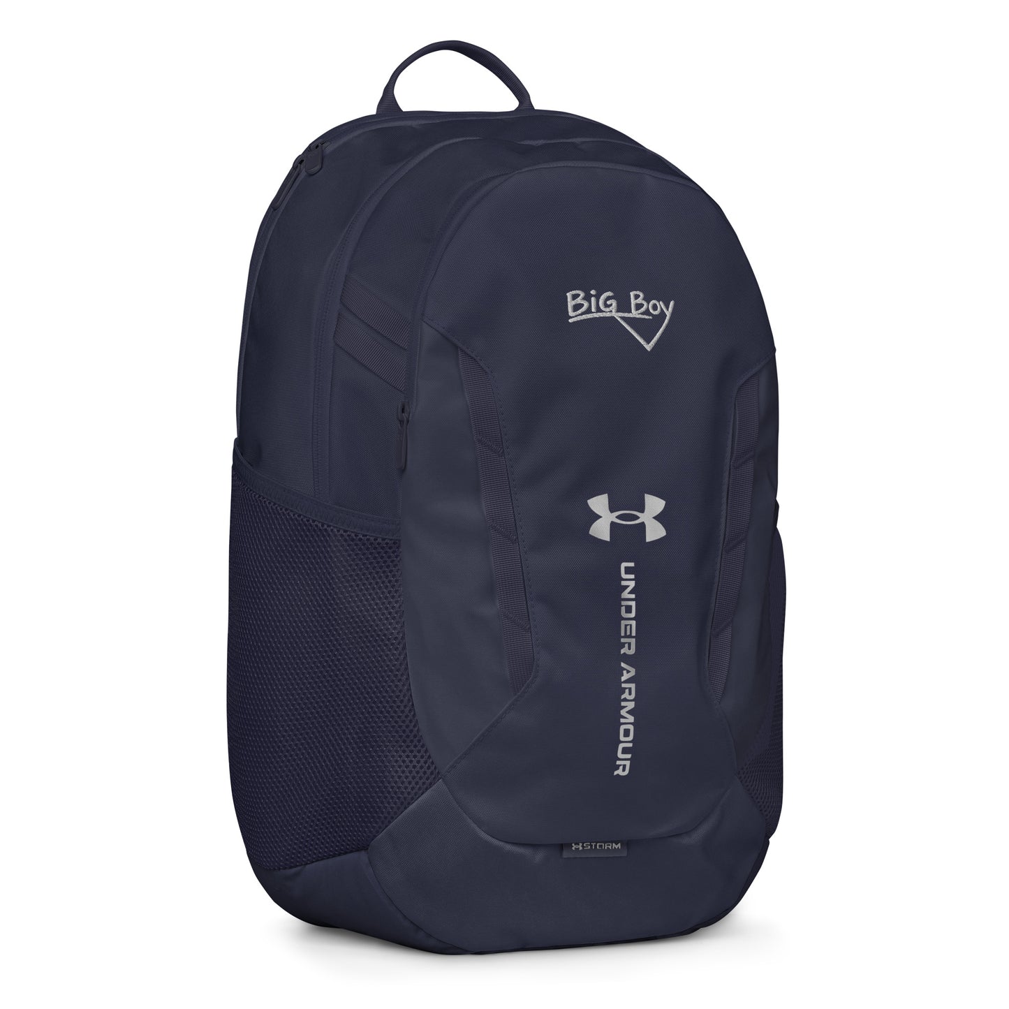 Navy Under Armour backpack featuring the classic white chalk-style "Big Boy" script logo on the top front panel. A silver Under Armour logo is centered above the vertical text "UNDER ARMOUR". The bottom of the bag features the UA Storm technology badge.