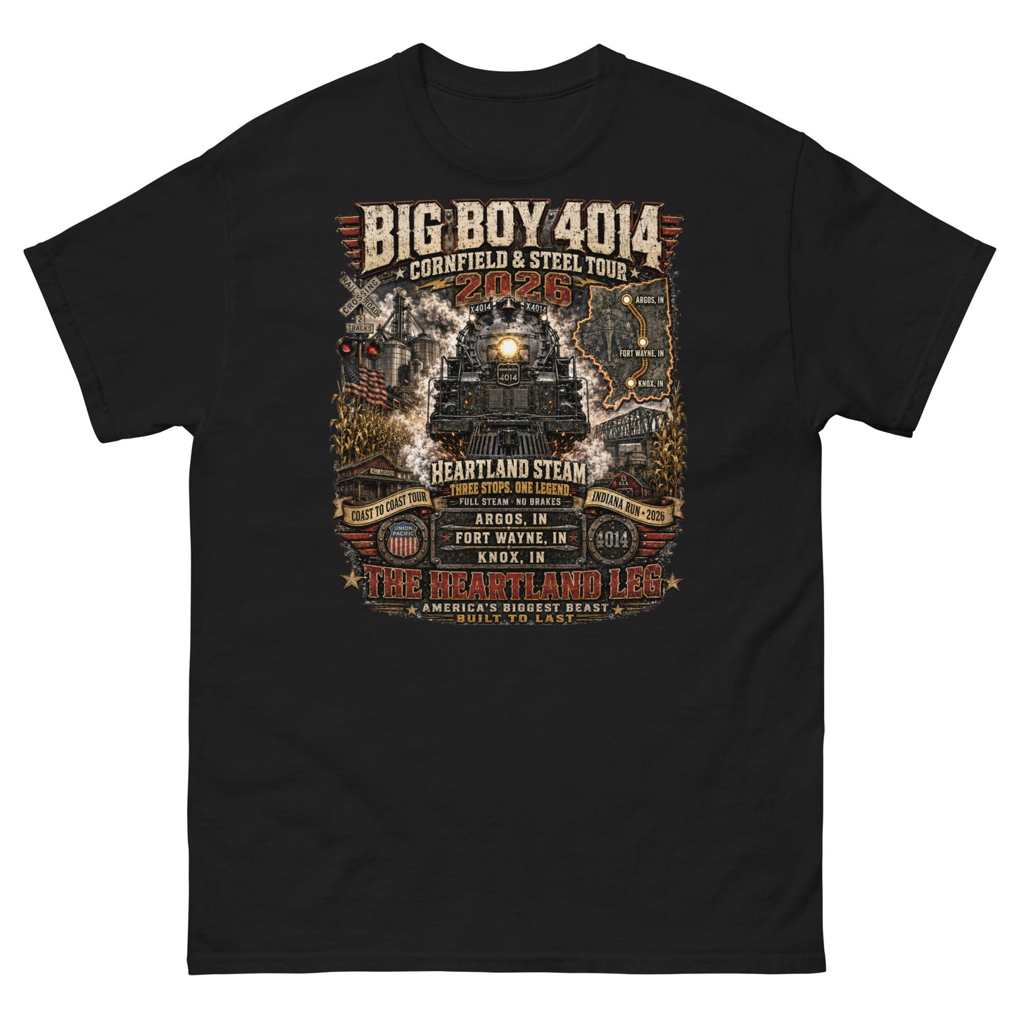Black t-shirt featuring a highly detailed graphic of the Big Boy 4014 steam locomotive surrounded by cornfields, grain silos, and a steel bridge. Text reads "BIG BOY 4014", "CORNFIELD & STEEL TOUR 2026", "HEARTLAND STEAM", alongside banners for "COAST TO COAST TOUR" and "INDIANA RUN - 2026", plus a map and detailed roster of three Indiana tour stops: Argos, IN; Fort Wayne, IN; and Knox, IN above the text "THE HEARTLAND LEG".