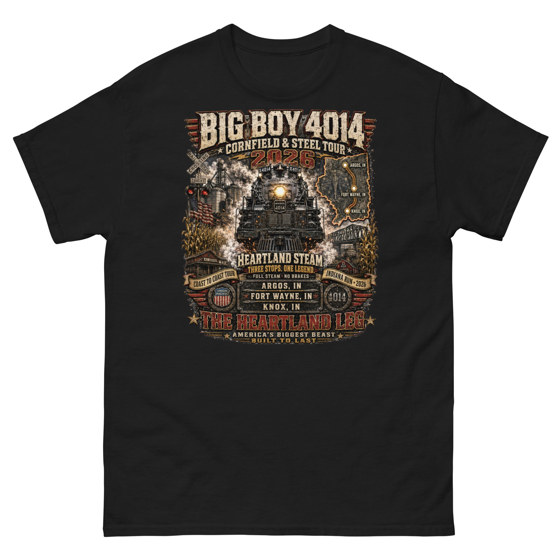 Black t-shirt featuring a highly detailed graphic of the Big Boy 4014 steam locomotive surrounded by cornfields, grain silos, and a steel bridge. Text reads "BIG BOY 4014", "CORNFIELD & STEEL TOUR 2026", "HEARTLAND STEAM", alongside banners for "COAST TO COAST TOUR" and "INDIANA RUN - 2026", plus a map and detailed roster of three Indiana tour stops: Argos, IN; Fort Wayne, IN; and Knox, IN above the text "THE HEARTLAND LEG".