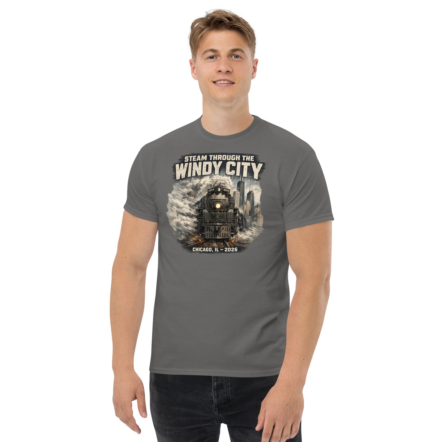 Gray t-shirt featuring a graphic of a steam locomotive emerging from smoke in front of a city skyline, with text reading "STEAM THROUGH THE WINDY CITY" at the top and "CHICAGO, IL - 2026" at the bottom.