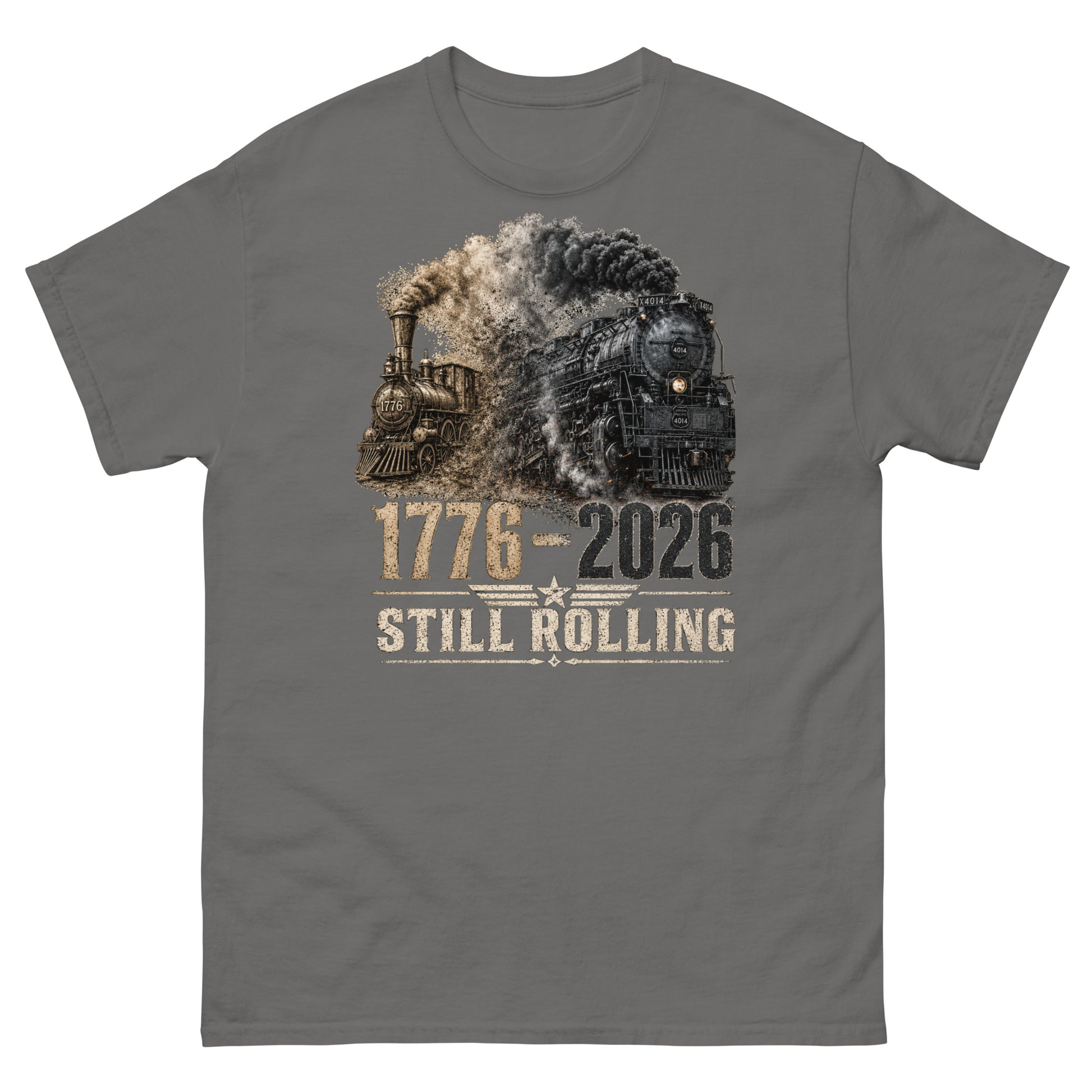 Gray t-shirt featuring a detailed graphic of two steam locomotives from different eras emerging from heavy smoke side-by-side, with bold distressed text reading "1776-2026" and "STILL ROLLING" flanked by a vintage star and wings emblem.