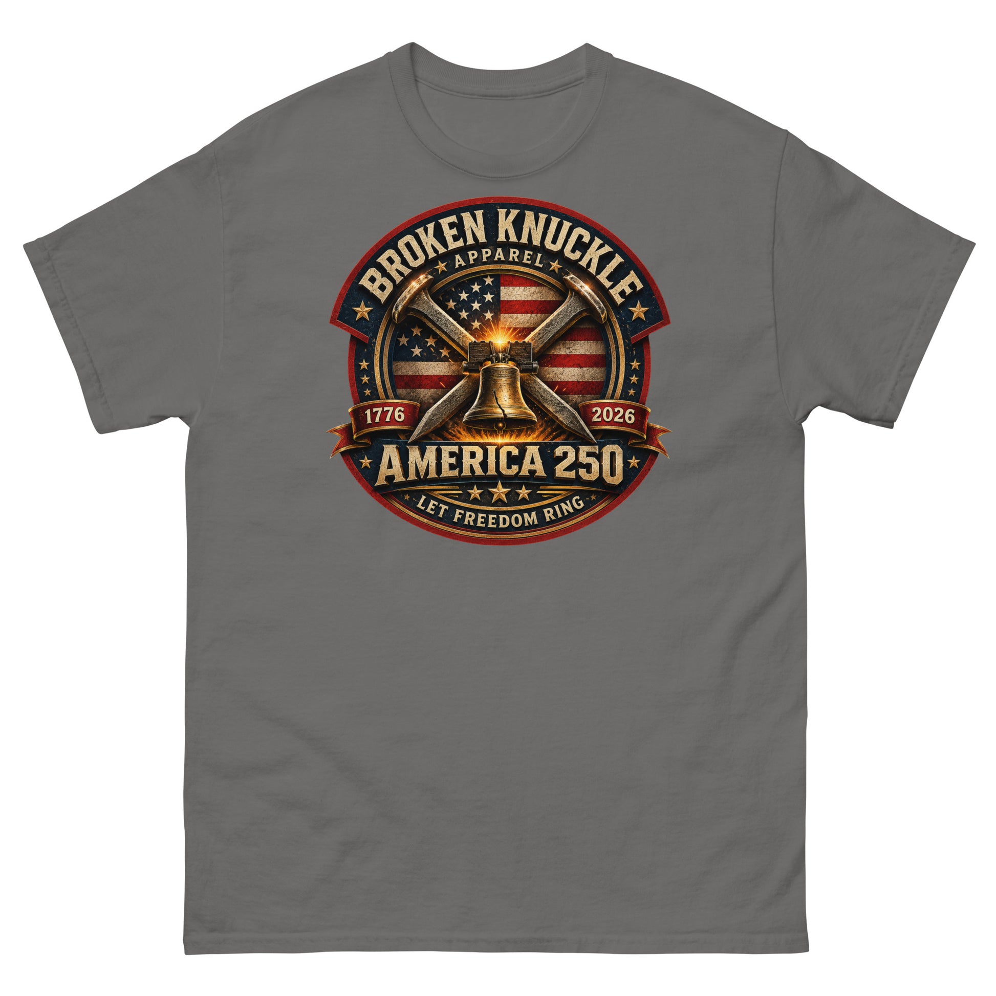 Gray t-shirt featuring a circular patriotic graphic. The design includes an American flag background, two crossed railroad spikes, and a glowing Liberty Bell in the center. Text around the badge reads "BROKEN KNUCKLE APPAREL", "1776", "2026", "AMERICA 250", and "LET FREEDOM RING".