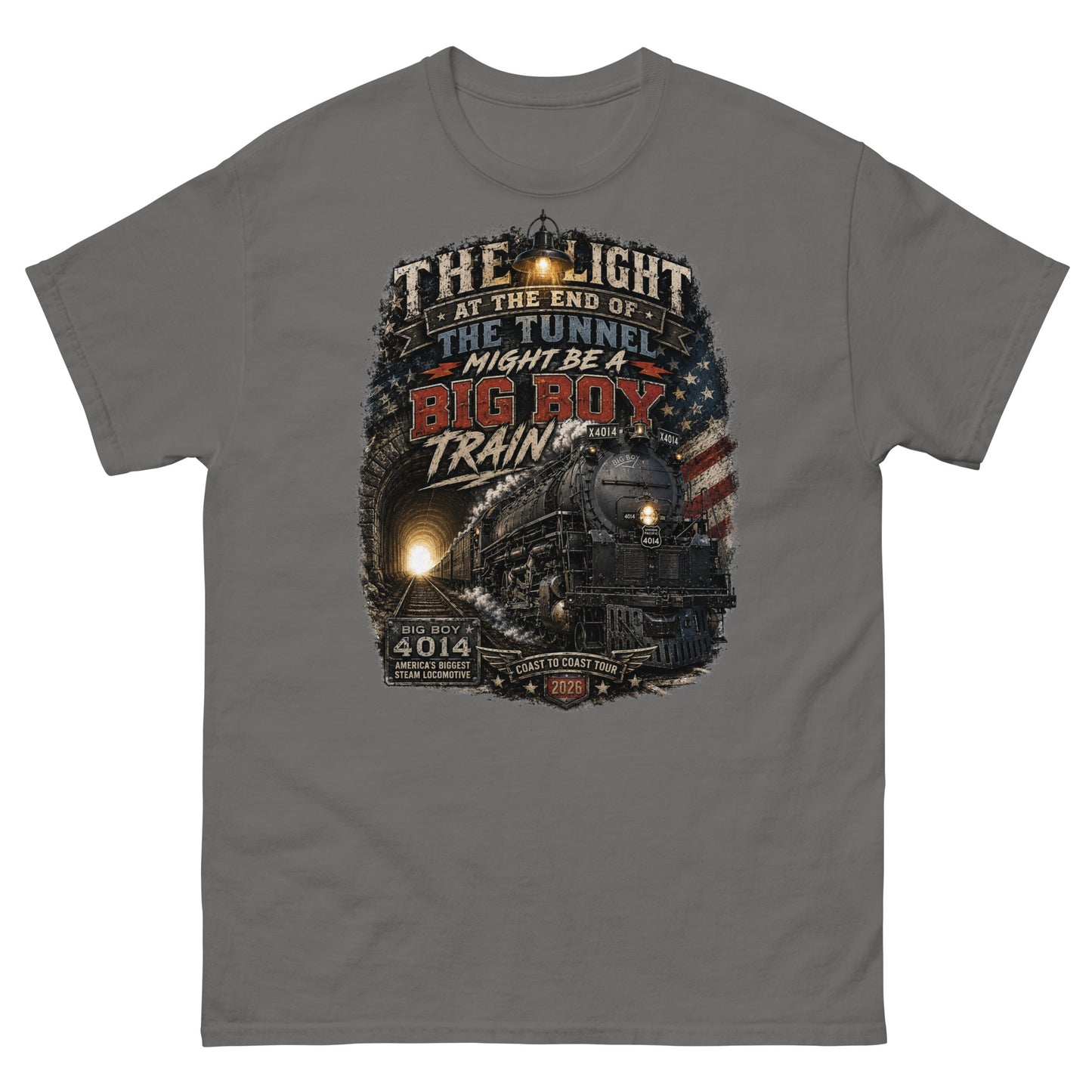 Gray t-shirt featuring a highly detailed vintage graphic. The design shows the Big Boy 4014 steam locomotive emerging from a dark tunnel with a glowing light behind it. A vintage lantern hangs at the top, and a distressed American flag is on the right. Bold text reads "THE LIGHT AT THE END OF THE TUNNEL MIGHT BE A BIG BOY TRAIN". Bottom badges read "BIG BOY 4014 AMERICA'S BIGGEST STEAM LOCOMOTIVE" and "COAST TO COAST TOUR 2026".