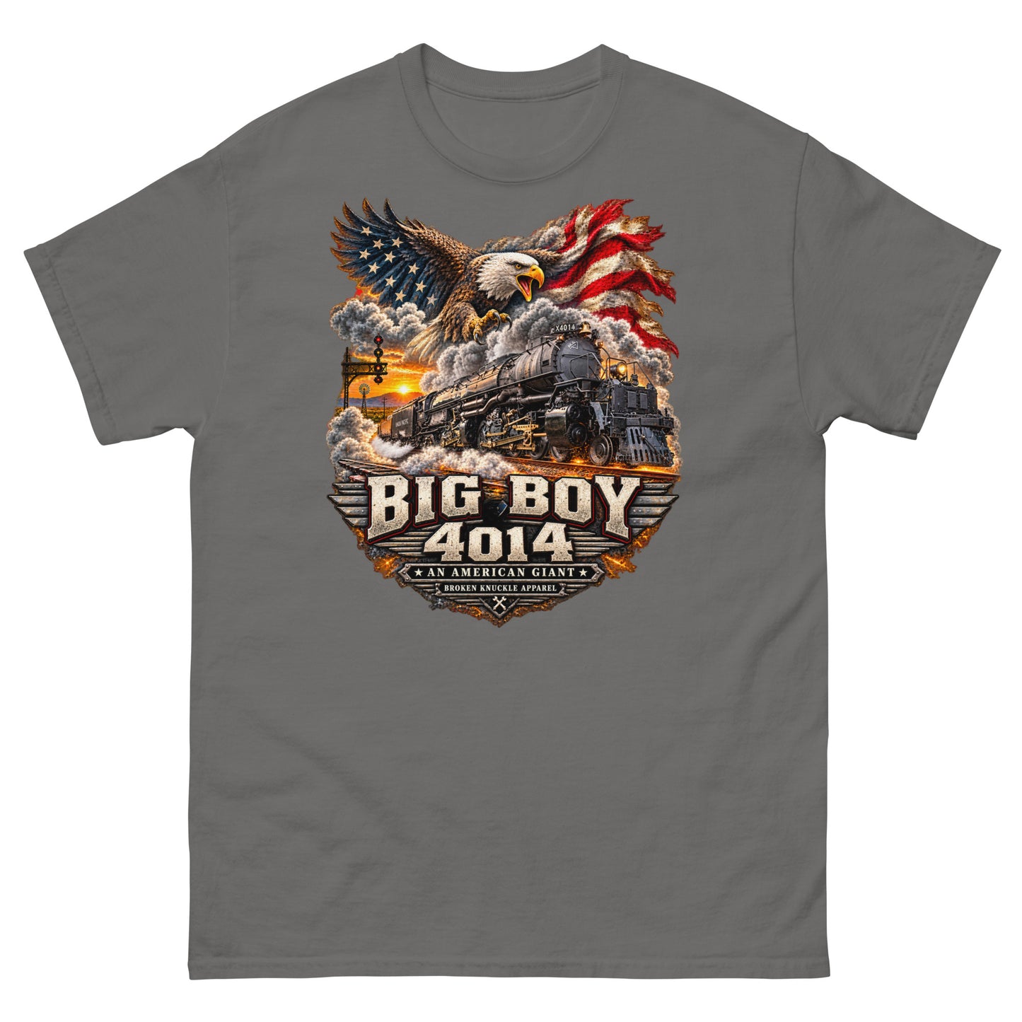 Charcoal classic t-shirt featuring a highly detailed patriotic graphic. A bald eagle and American flag soar above the Big Boy 4014 steam locomotive charging down the tracks at sunset. Bold metallic-style text reads "BIG BOY 4014" above a banner reading "AN AMERICAN GIANT" and the Broken Knuckle Apparel logo.