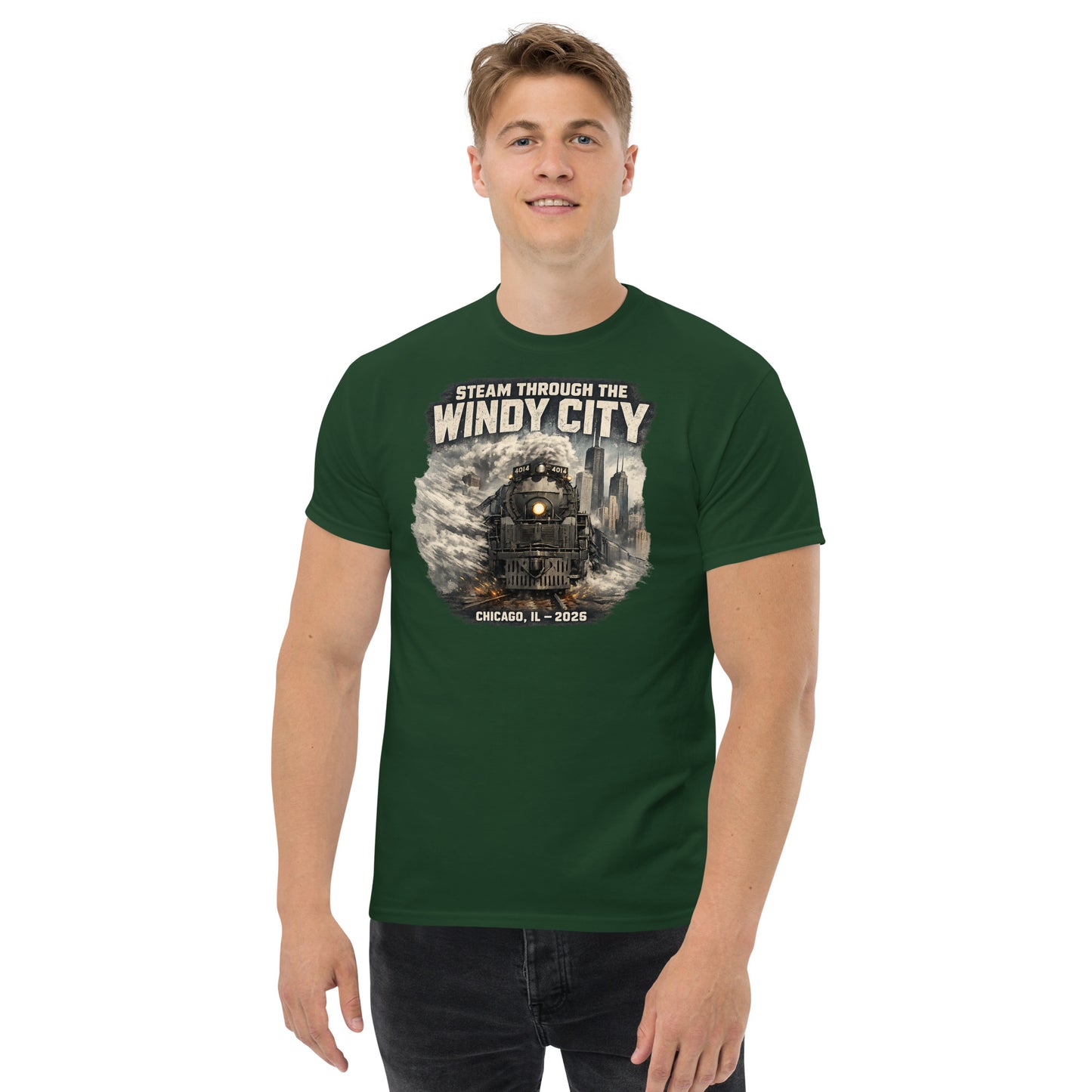 Forest green t-shirt featuring a graphic of a steam locomotive emerging from smoke in front of a city skyline, with text reading "STEAM THROUGH THE WINDY CITY" at the top and "CHICAGO, IL - 2026" at the bottom.
