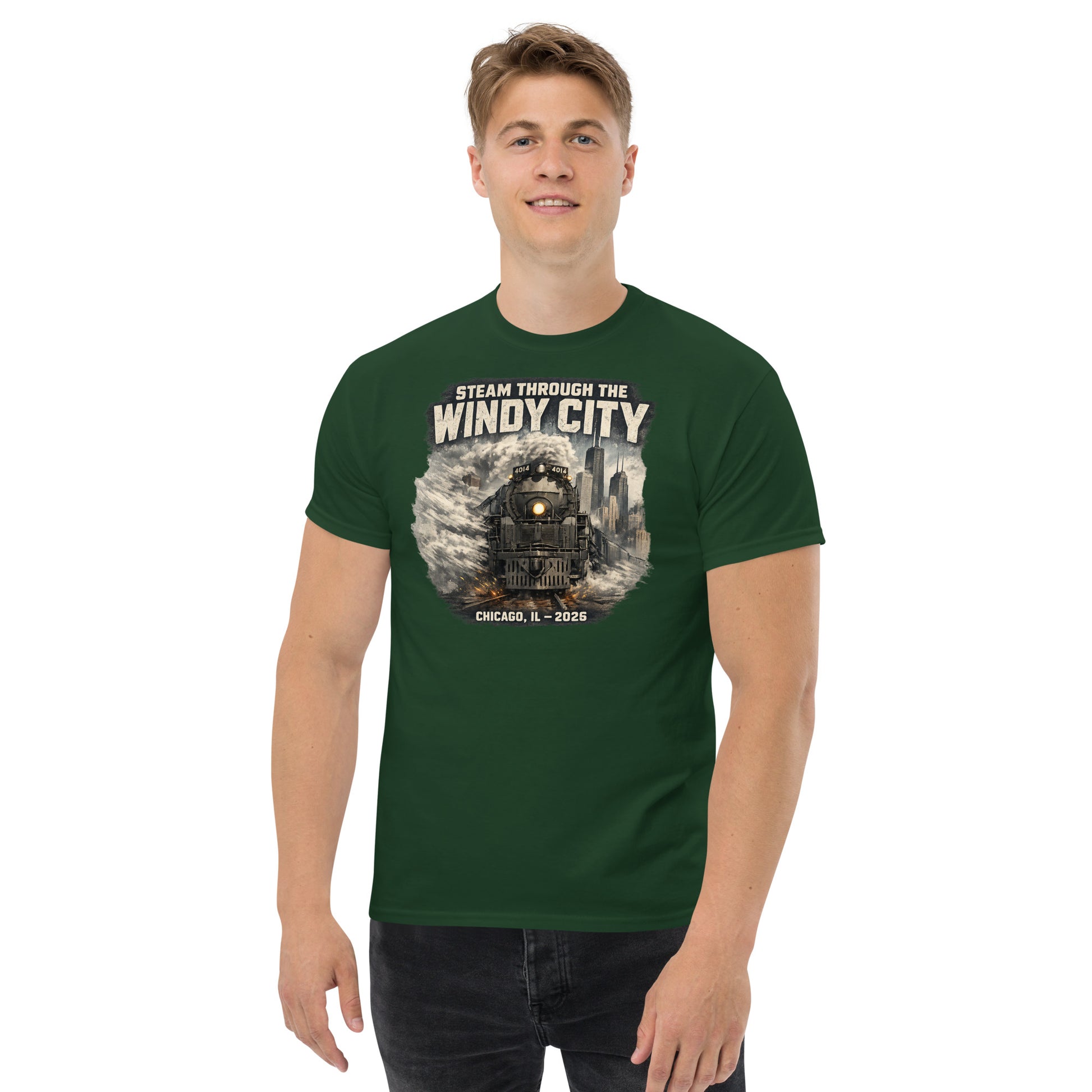 Forest green t-shirt featuring a graphic of a steam locomotive emerging from smoke in front of a city skyline, with text reading "STEAM THROUGH THE WINDY CITY" at the top and "CHICAGO, IL - 2026" at the bottom.